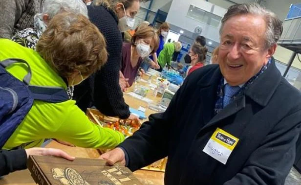 Richard Lugner verteilt Pizza im Ankunftszentrum.