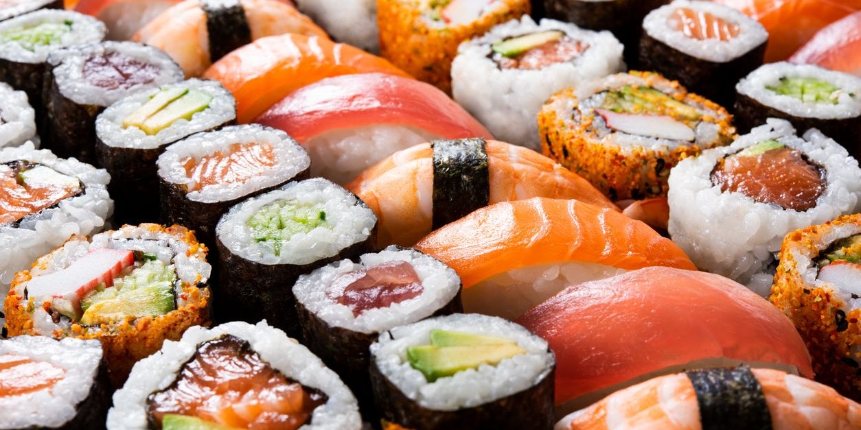 Overhead japanese sushi food. Maki ands rolls with tuna, salmon, shrimp, crab and avocado. Top view of assorted sushi, all you can eat menu. Rainbow sushi roll, uramaki, hosomaki and nigiri.