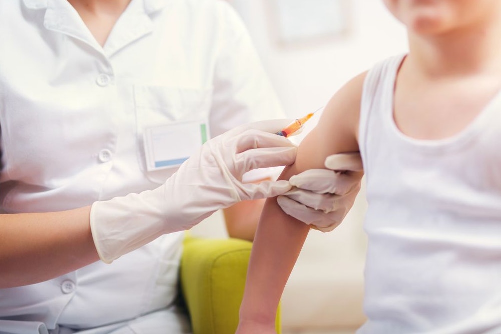 Pediatrician makes vaccination to small boy