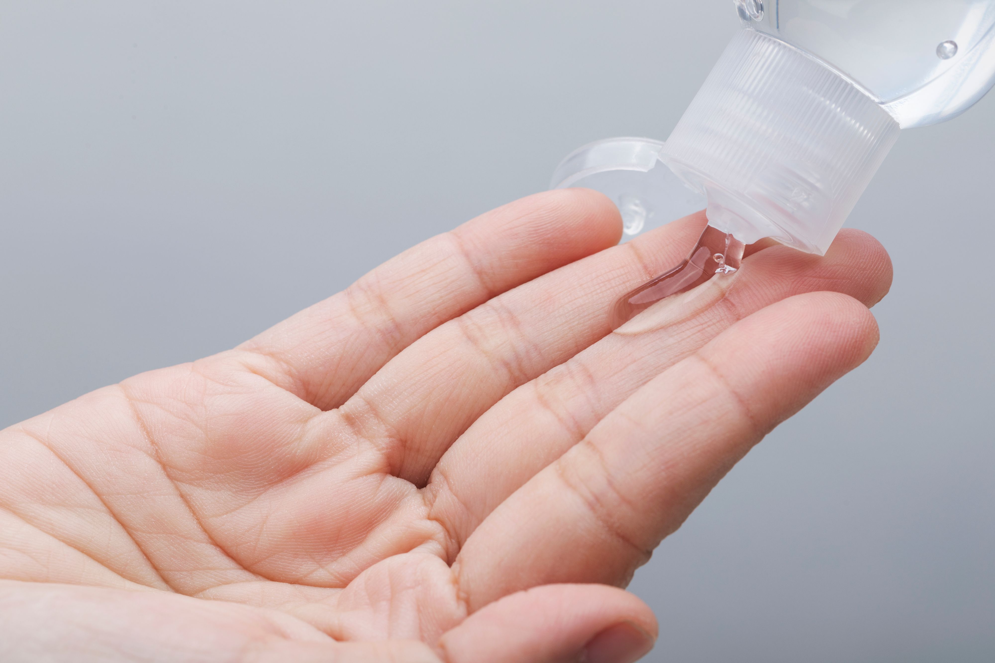 Hand sanitizer bottle using alcohol gel rub for corona virus hands hygiene coronavirus COVID-19 pandemic prevention.