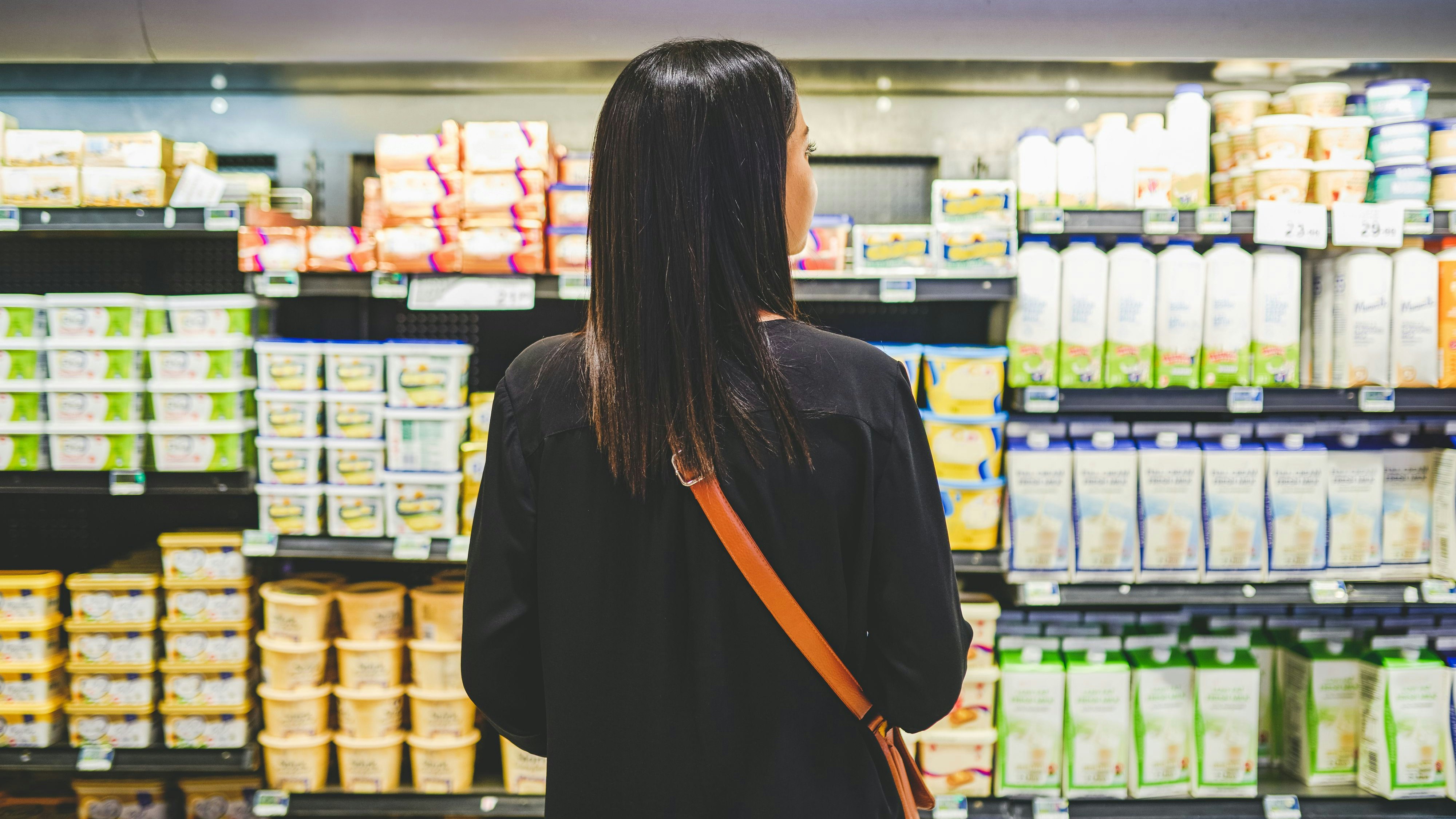 Rearview shot of a young woman shopping in a grocery store
