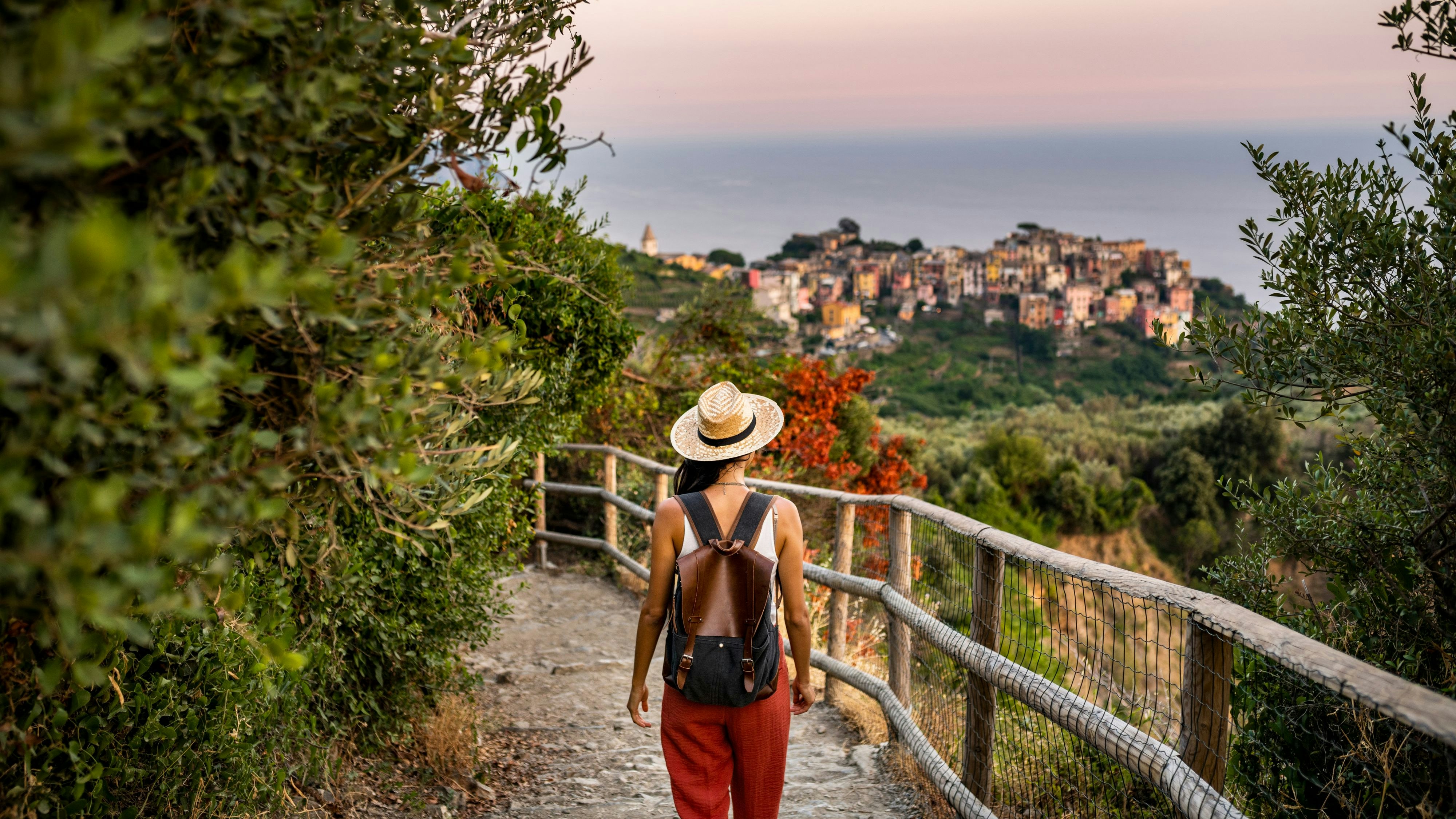 Female tourist walking towards Corniglia village, Beautiful town in Cinque Terre coast