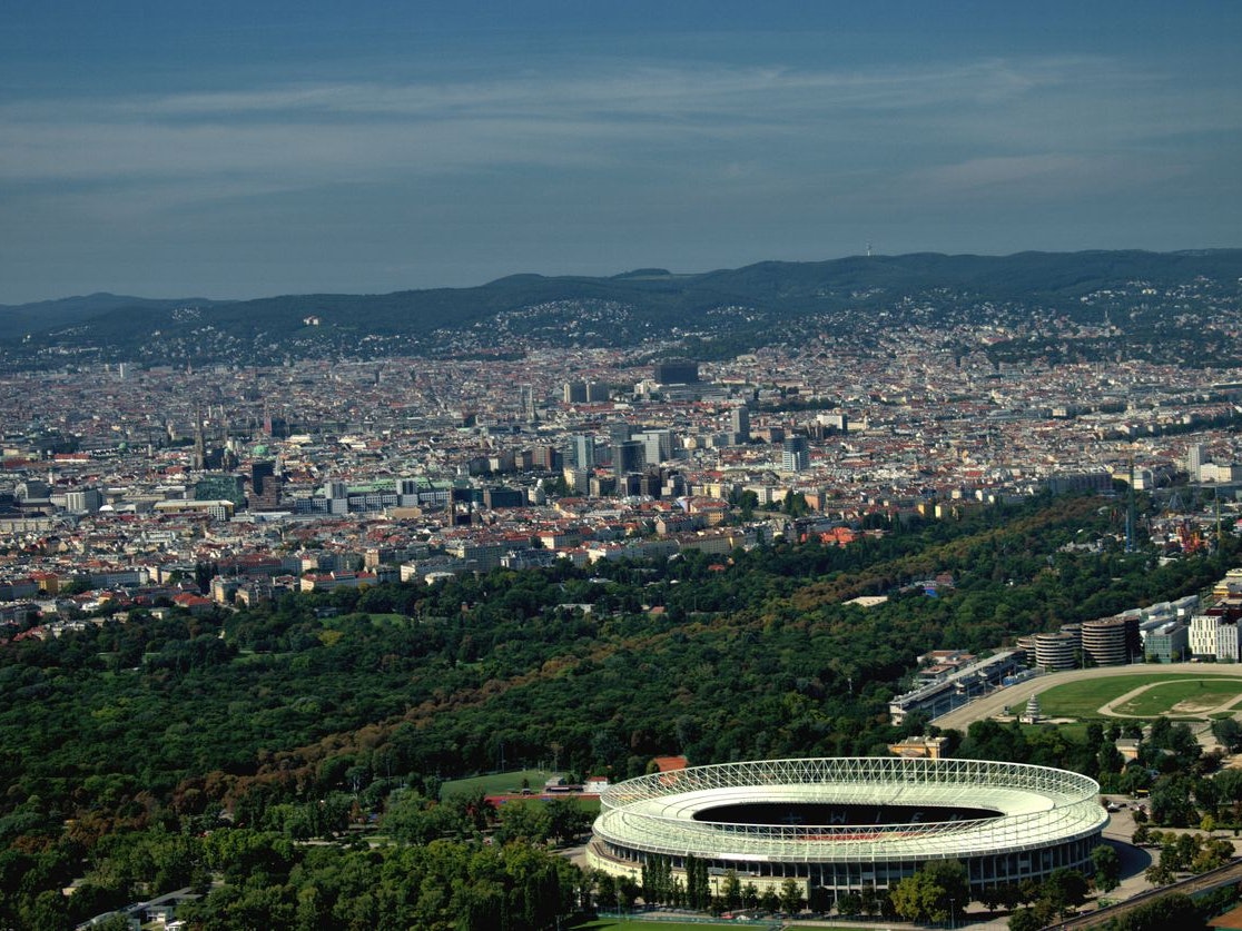 Ernst Happel football stadium in front of some buildings surrounded with grren trees which convert carbon dioxide back to oxygen when they do a so called photosynthesis in the city of Vienna the capitol of Austria seen from above during a flight in a small plane September 11,2020