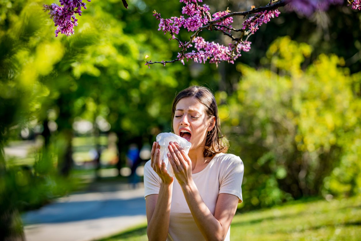 Woman has sneezing. Young woman is having flu and she is sneezing. Sickness, seasonal virus problem concept. Woman being sick having flu sneezing.