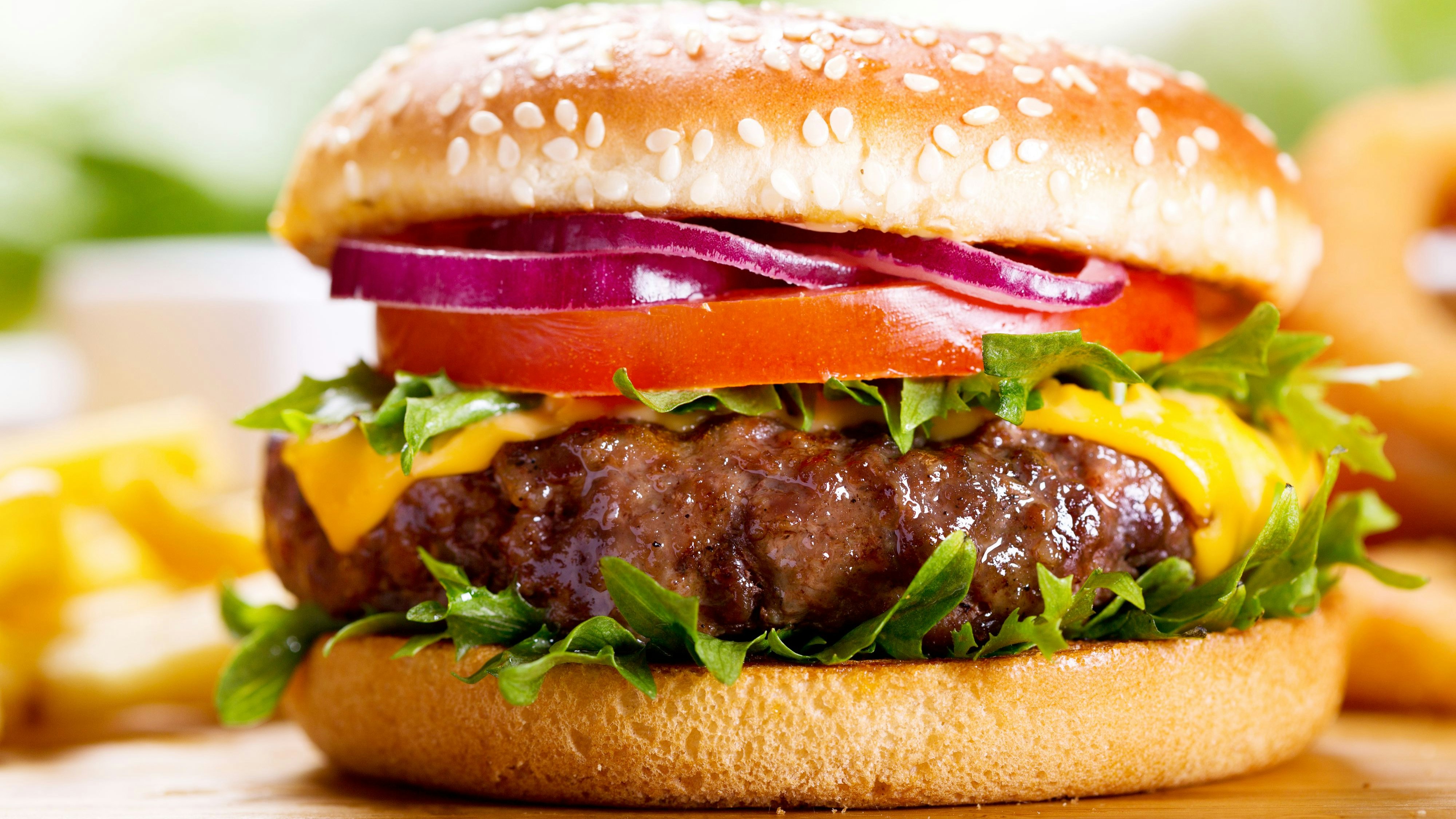 hamburger with fries on wooden table