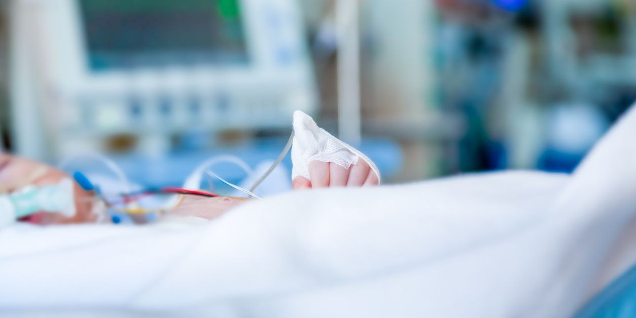Child infant in intensive care unit. Shallow depth of field in profile with blurred background.