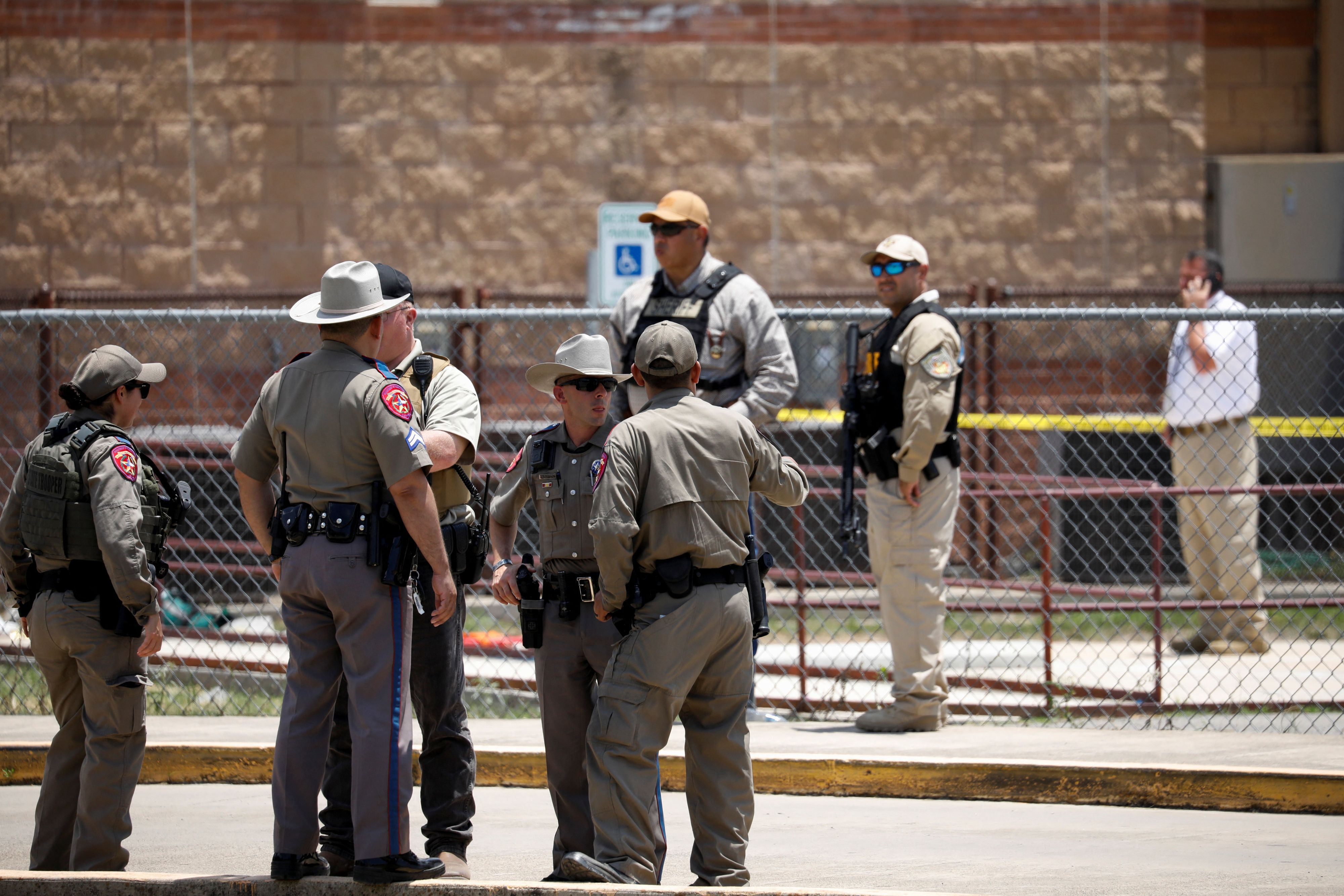 Law enforcement officers guard the scene of a shooting at Robb Elementary School in Uvalde, Texas, U.S. May 24, 2022.  REUTERS/Marco Bello