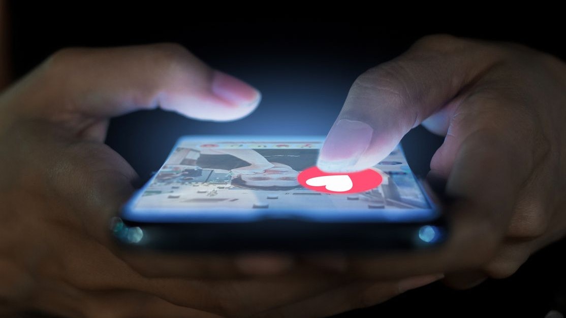 A woman using a phone for a dating app