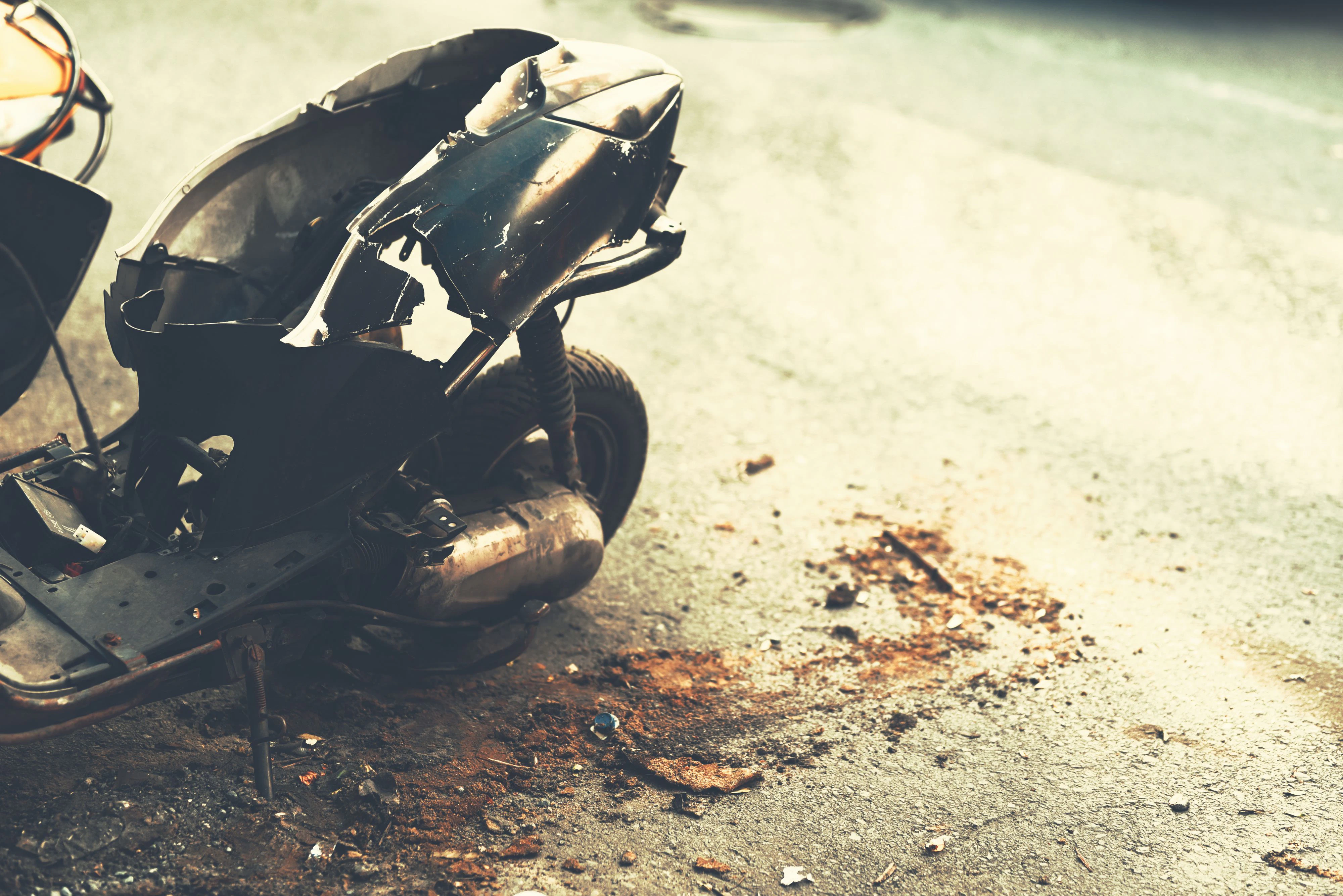 crashed scooter after road accident