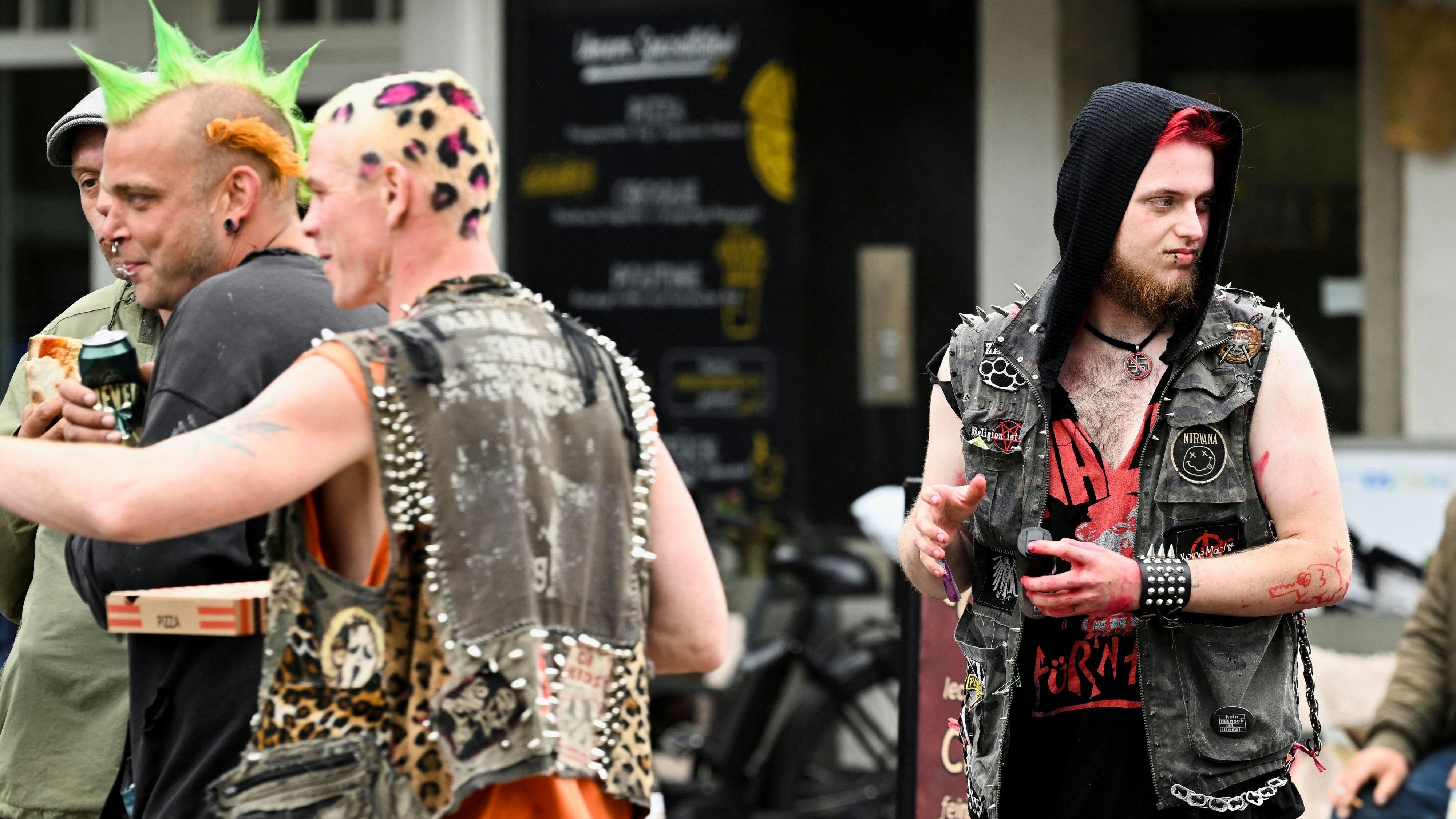 People, who travelled with a special nine euro ticket offered by public transport operators and Deutsche Bahn, a German national railway company, that allows the usage of local buses and trains nationwide for a month, enjoy their beers in downtown Westerland on the German island of Sylt, Germany, June 4, 2022. REUTERS/Fabian Bimmer