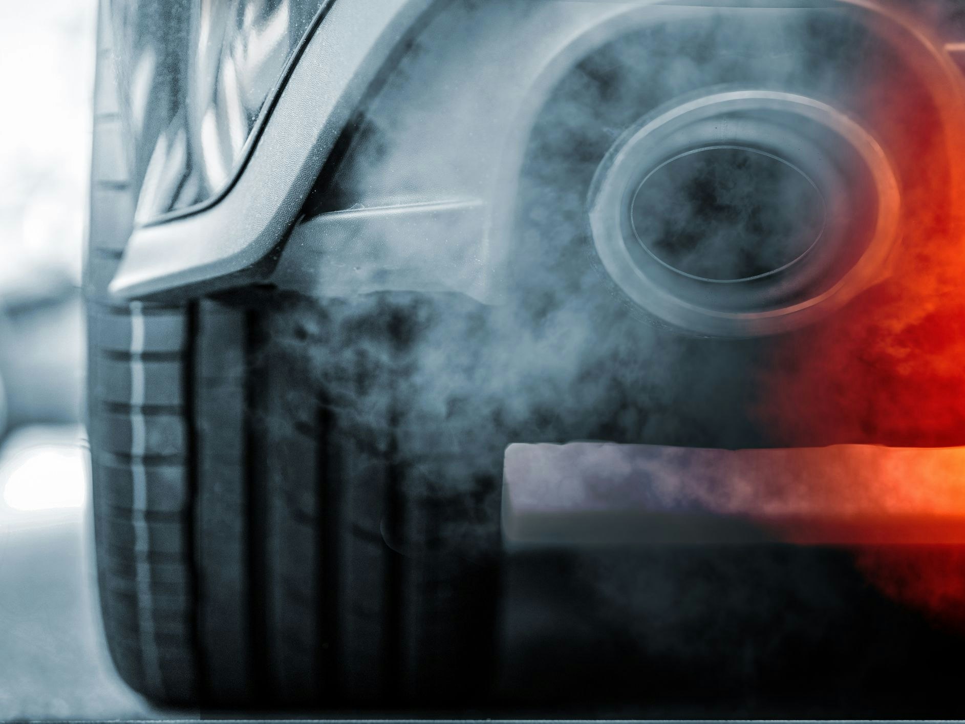 Smoke emission from exhaust pipe of SUV car - concept of pollution
