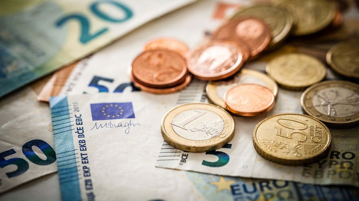 Close up view of European Union banknotes and coins. Selective focus on the one Euro coin. DSRL studio photo taken with Canon EOS 5D Mk II and Canon EF 100mm f/2.8L Macro IS USM.