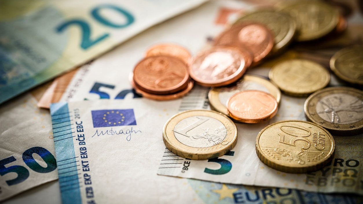 Close up view of European Union banknotes and coins. Selective focus on the one Euro coin. DSRL studio photo taken with Canon EOS 5D Mk II and Canon EF 100mm f/2.8L Macro IS USM.