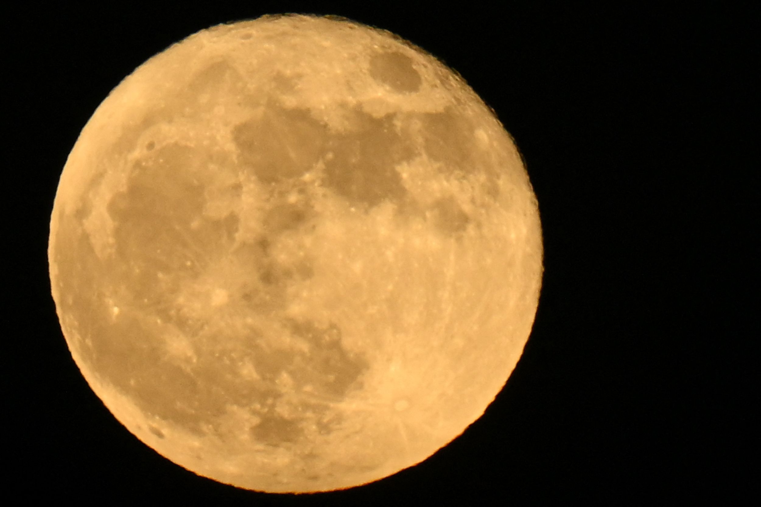 The "Strawberry supermoon" full moon rises on June 14, 2022 as seen from Lawndale, California. 