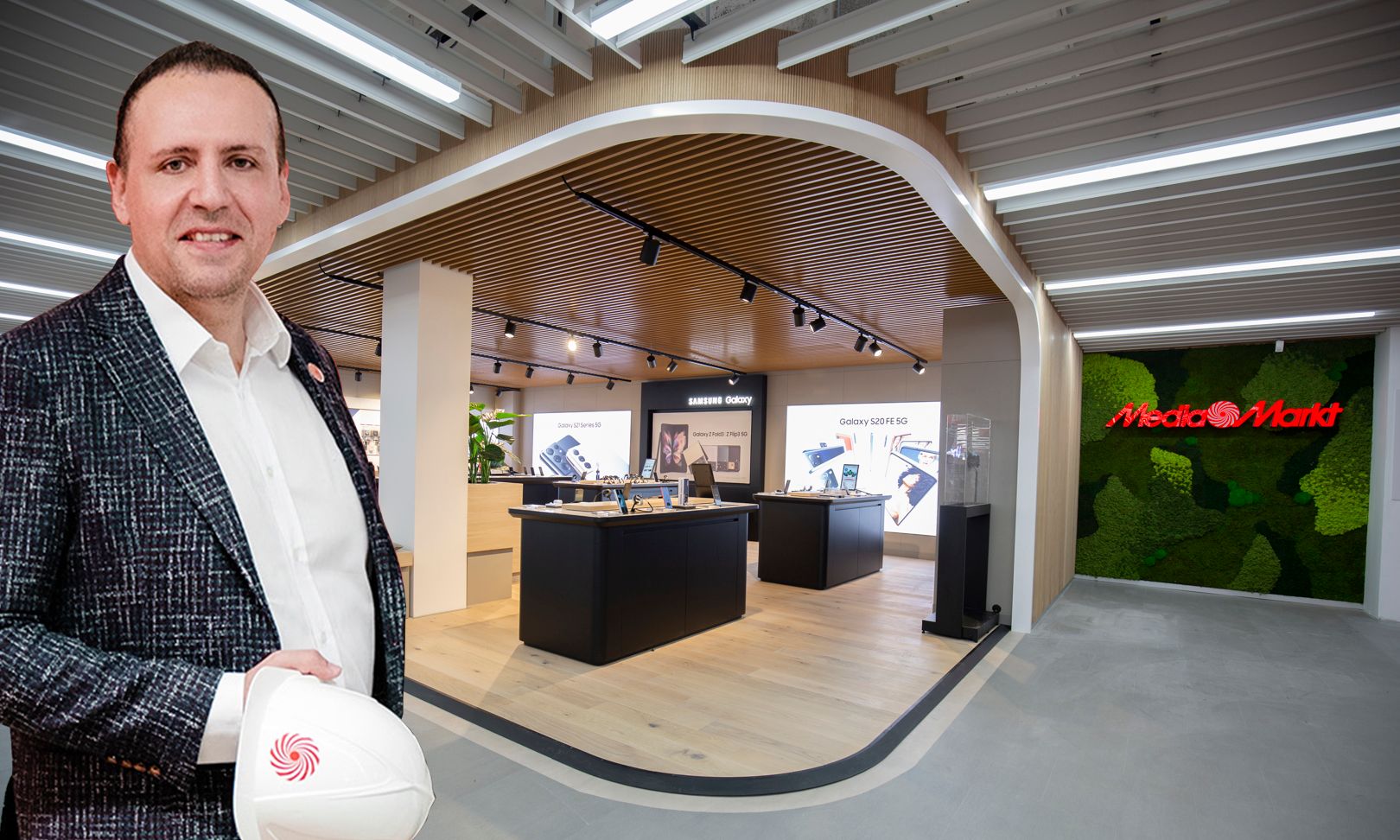 Österreichs MediaMarkt-Chef Alpay Güner, im Hintergrund ein Blick ins 