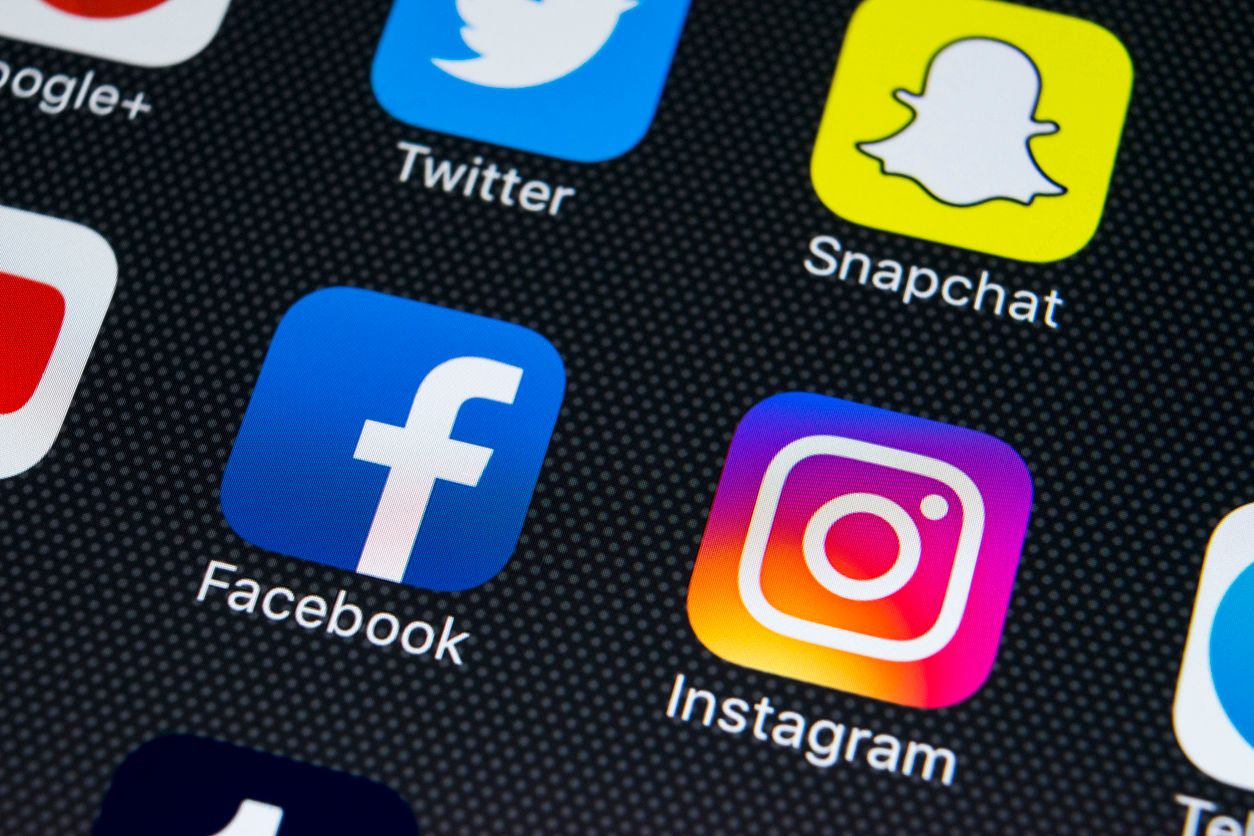 Sankt-Petersburg Russia February 23, 2018: Apple iPhone X on office desk with icons of social media facebook, instagram, twitter, snapchat application on screen. Social network. Starting social media app. Photo taken at company office