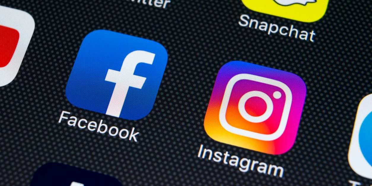 Sankt-Petersburg Russia February 23, 2018: Apple iPhone X on office desk with icons of social media facebook, instagram, twitter, snapchat application on screen. Social network. Starting social media app. Photo taken at company office