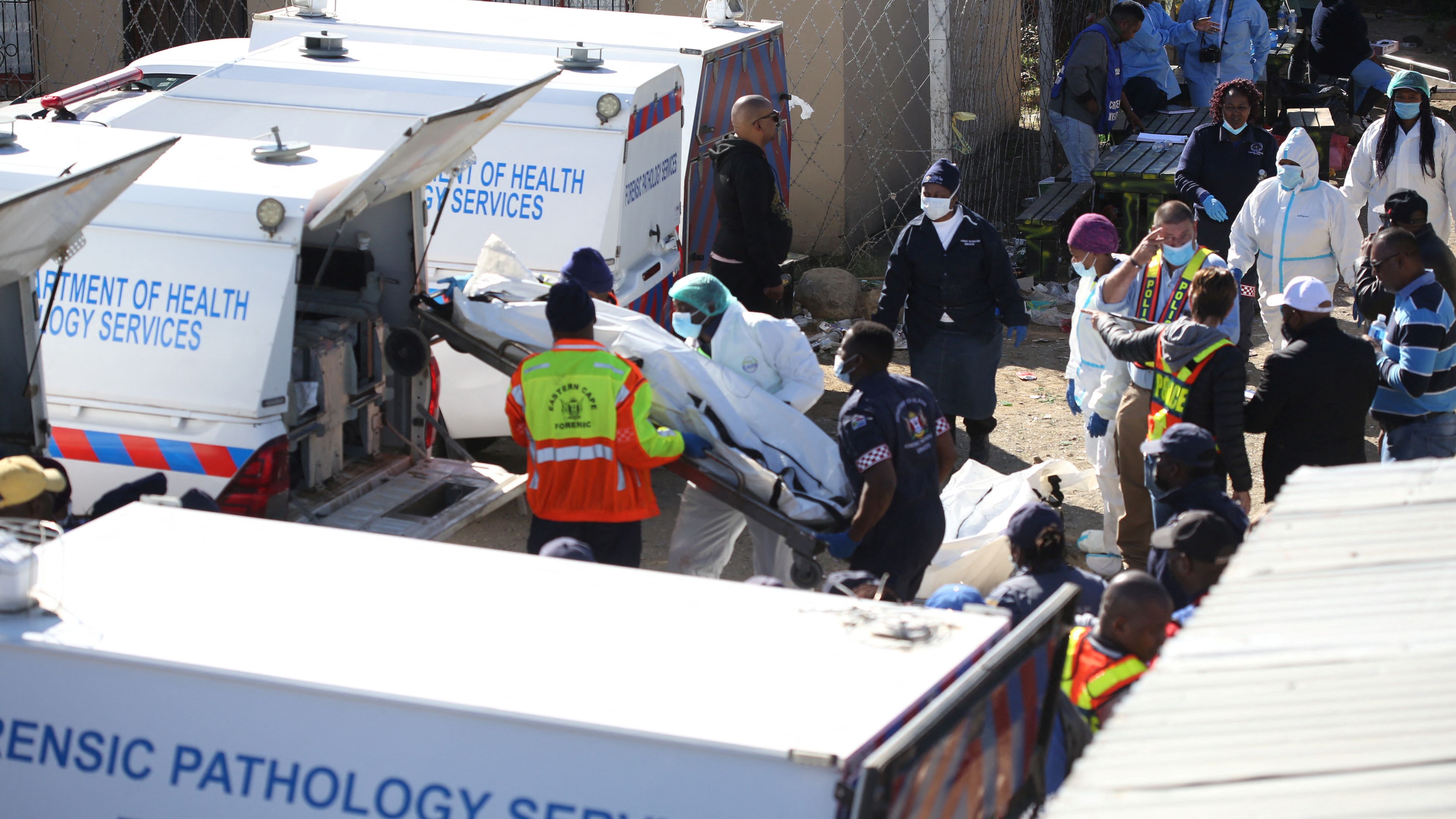 Forensic personnel load bodies of victims after the deaths of patrons found inside the Enyobeni Tavern, in Scenery Park, outside East London in the Eastern Cape province, South Africa, June 26, 2022. REUTERS/Stringer NO RESALES. NO ARCHIVES. SOUTH AFRICA OUT. NO COMMERCIAL OR EDITORIAL SALES IN SOUTH AFRICA