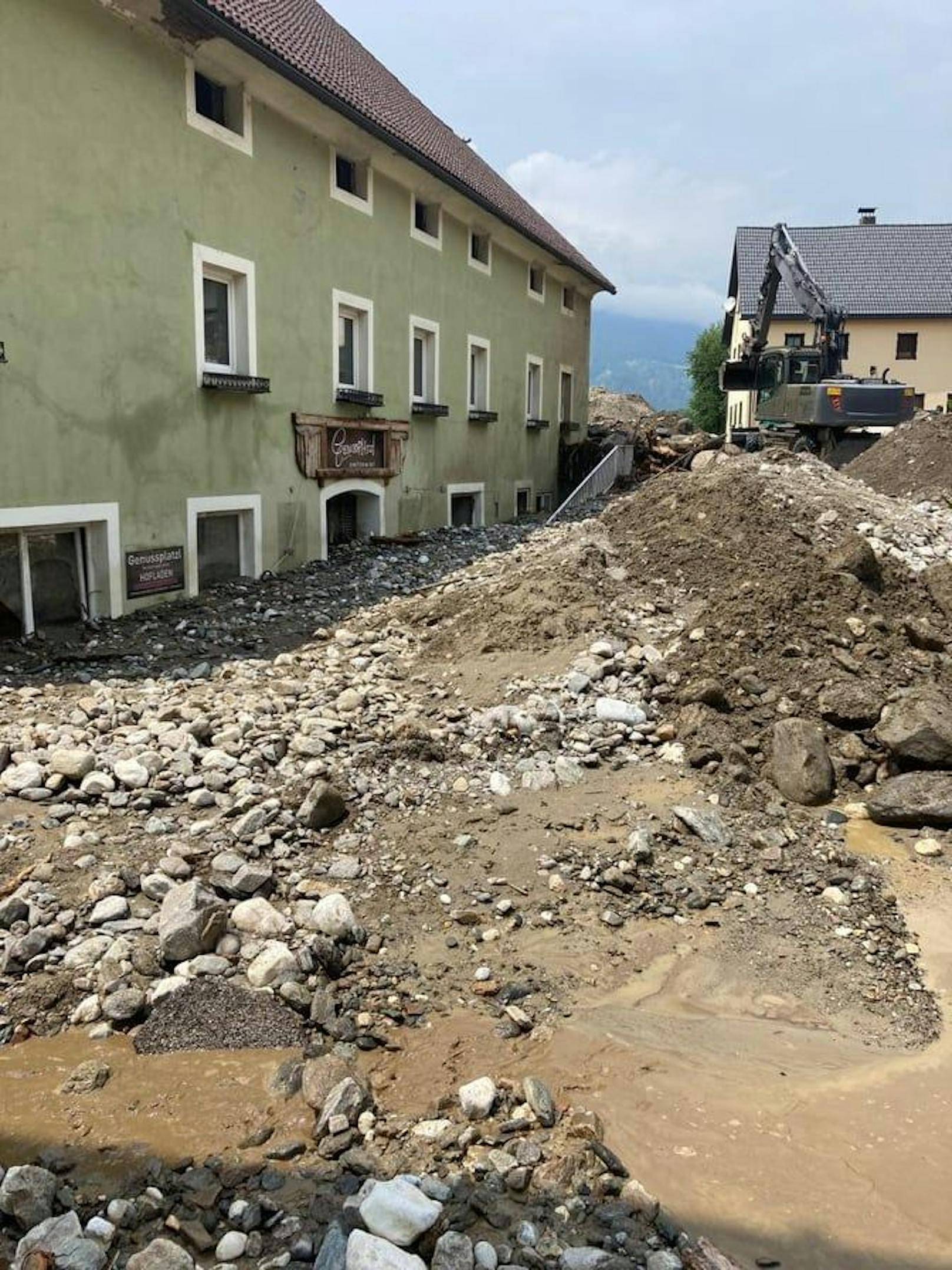 Riesige Stein- und Geröllmassen sind vor und im Haus zu sehen.