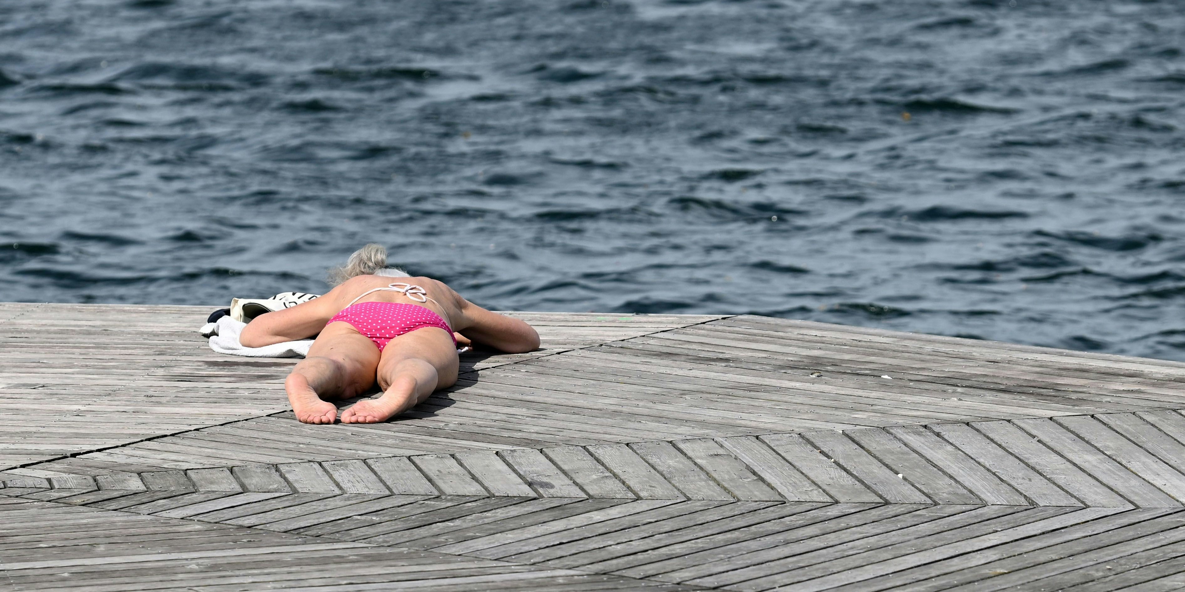 Eine Frau geniesst ein Sonnenbad an der Alten Donau in Wien (Archivfoto).