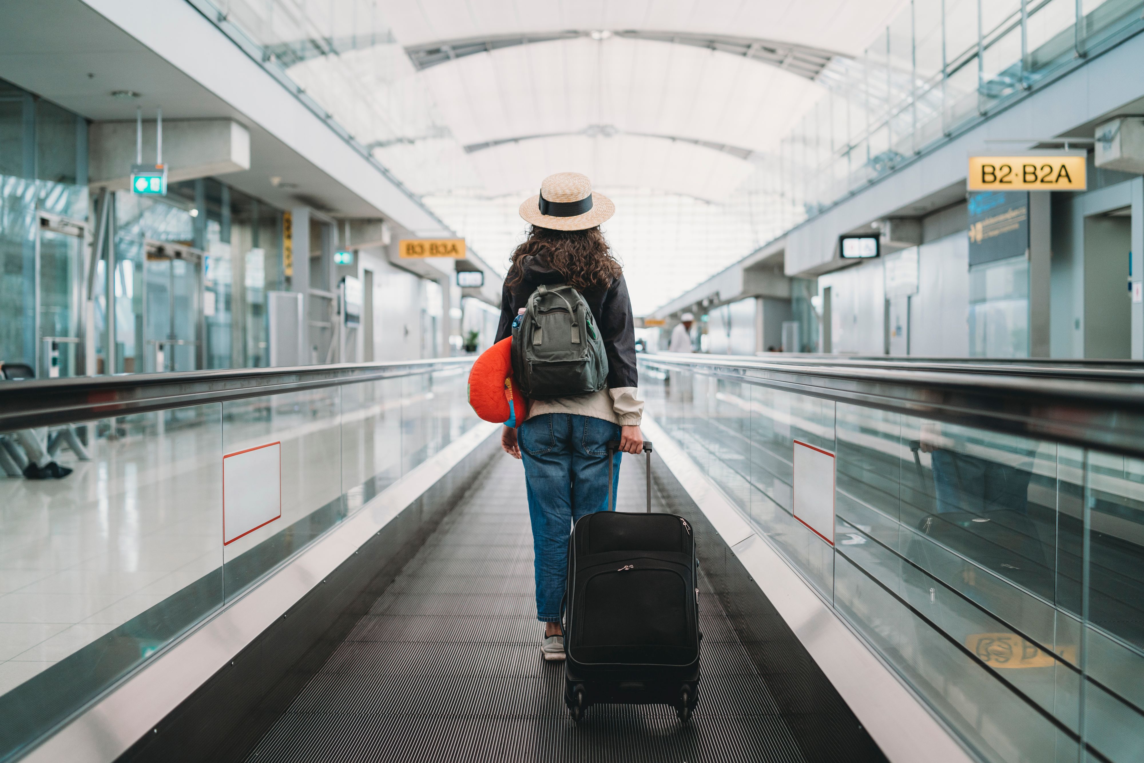 Young woman at the airport with a suitcase