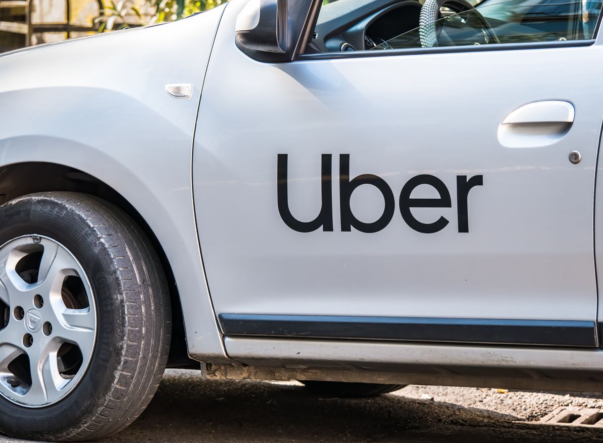 Bucharest/Romania - 10.17.2020: Uber logo inscriptioned on a white painted car. Uber car in traffic.