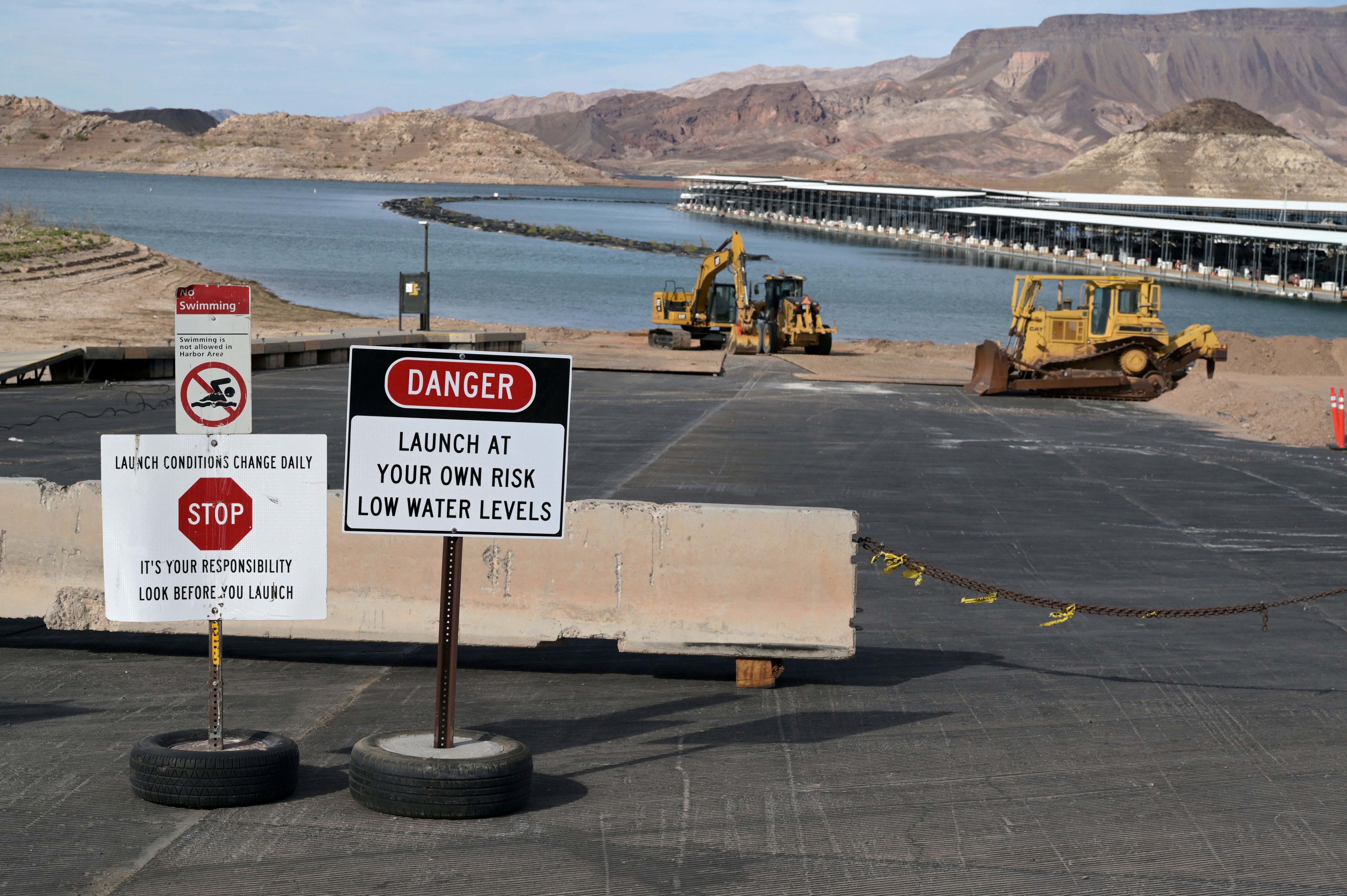 Signs notify a boat launch is closed because of low water levels due to drought  in the Hoover Dam reservoir of Lake Mead near Las Vegas, Nevada, U.S. June 9, 2021. Picture taken June 9, 2021.  REUTERS/Bridget Bennett