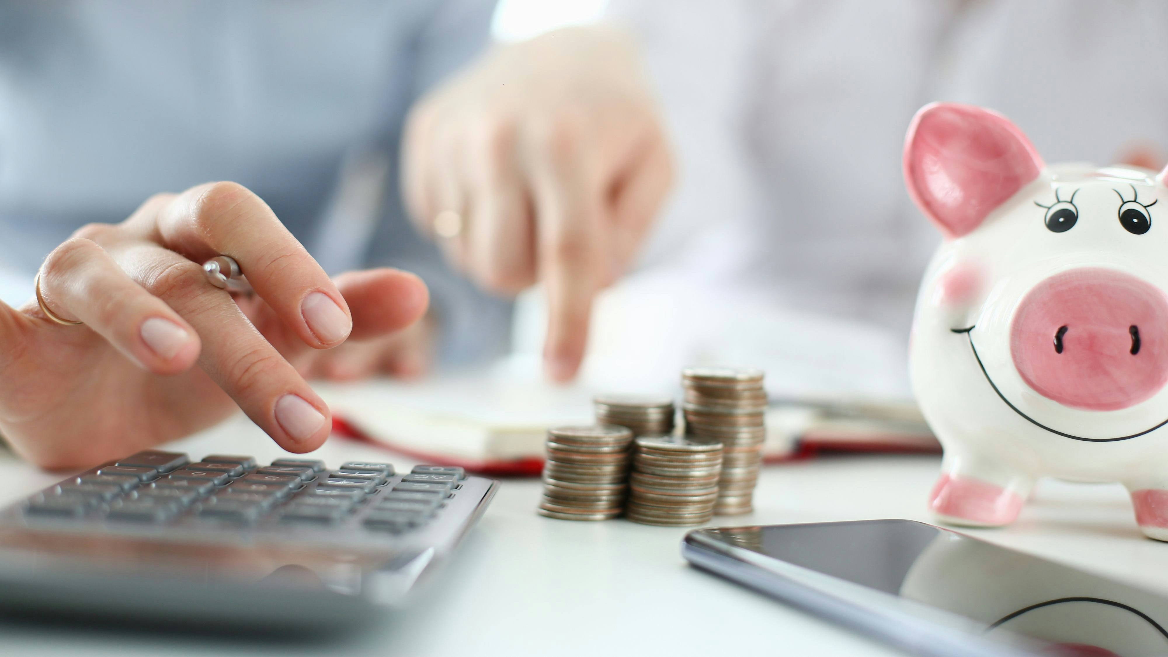 Man and woman hand consider on calculator expenses of family budget aganist home background. Lending purchase rental housing mortgage concept