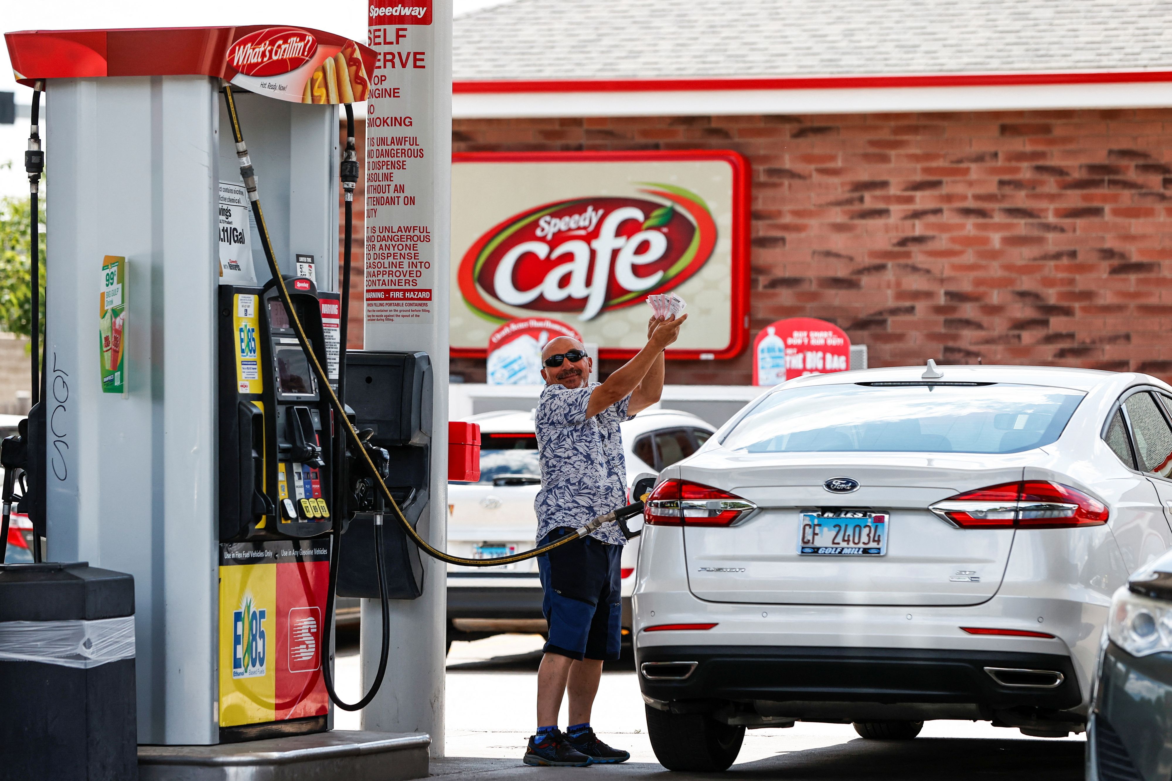 A customer shows his purchased lottery tickets outside the Speedway gas station, where the winning ticket for the Mega Millions lottery jackpot was sold, in Des Plaines, Illinois, U.S. July 30, 2022. REUTERS/Kamil Krzaczynski