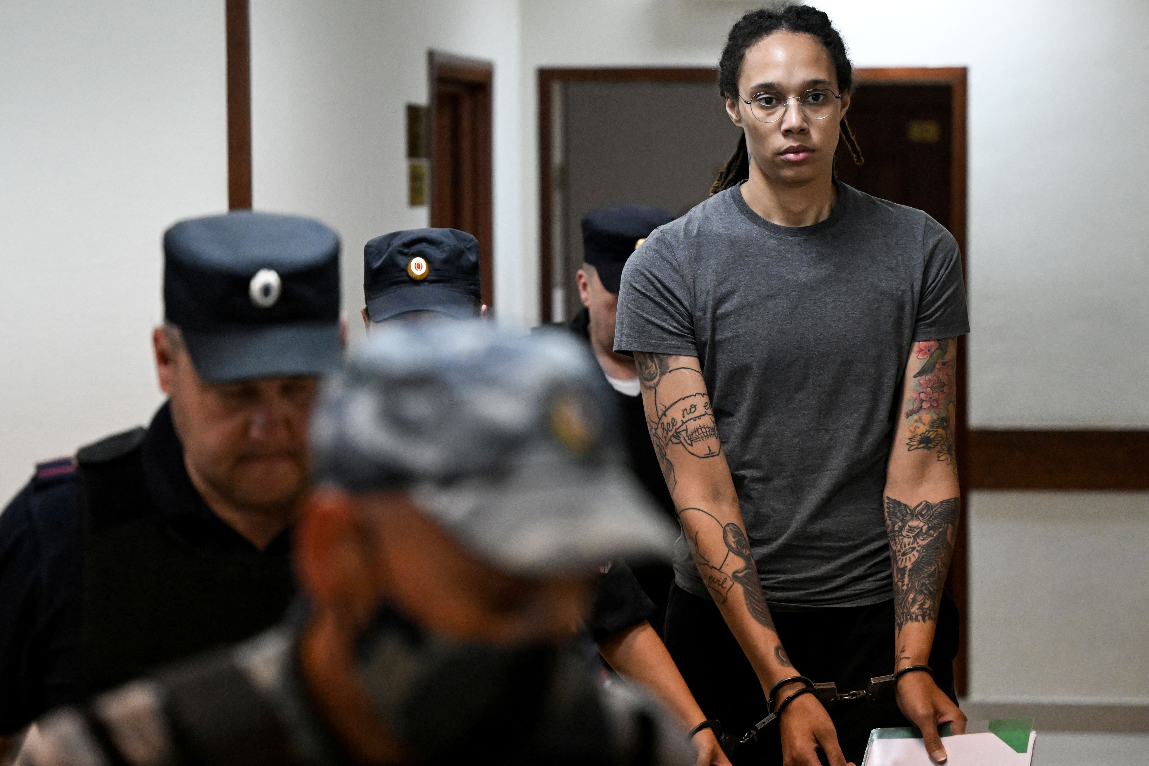 U.S. basketball player Brittney Griner, who was detained at Moscow's Sheremetyevo airport and later charged with illegal possession of cannabis, is escorted in a court building in Khimki outside Moscow, Russia August 4, 2022. Kirill Kudryavtsev/Pool via REUTERS 