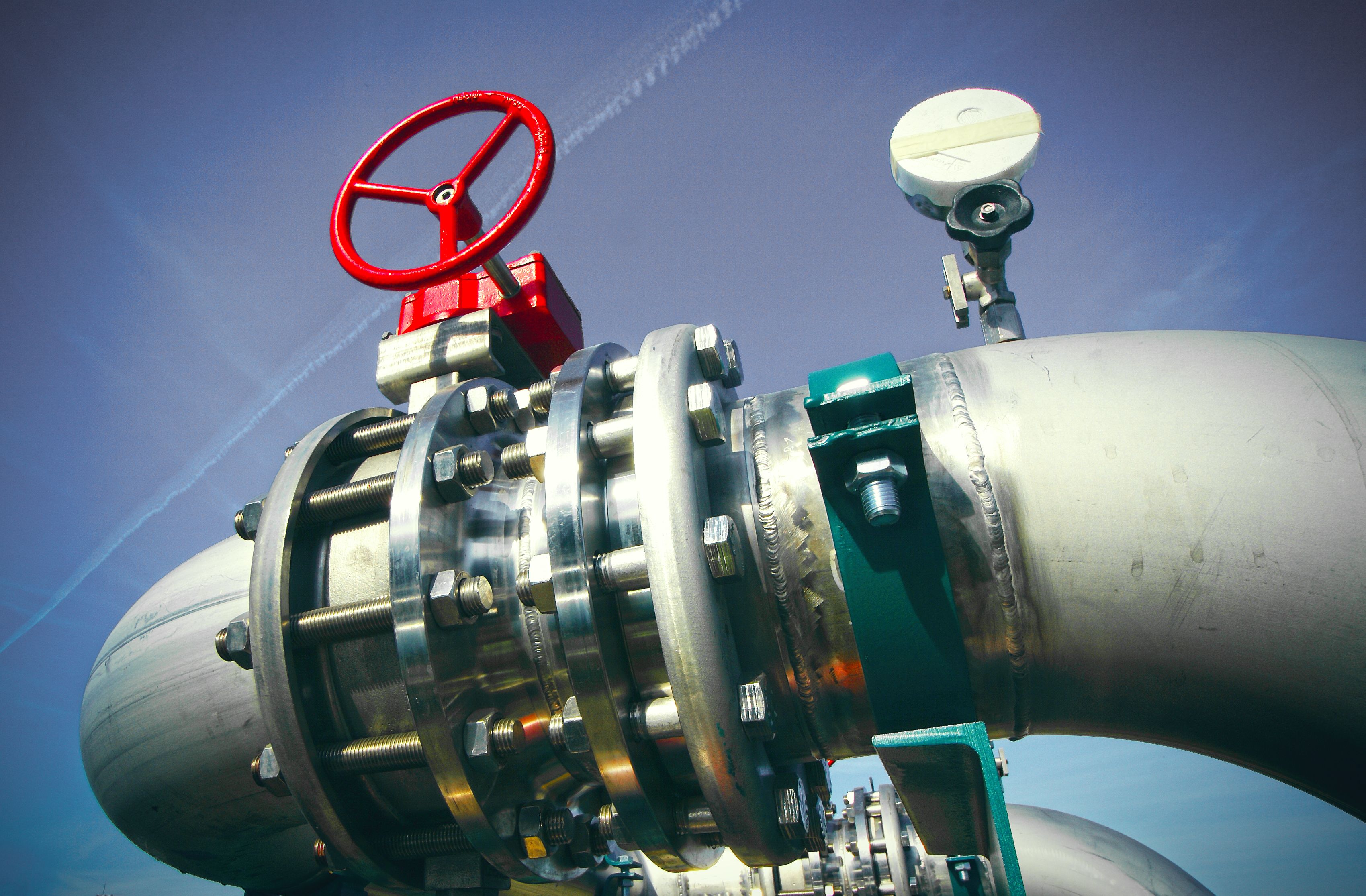 Industrial zone, Steel pipelines and valves against blue sky