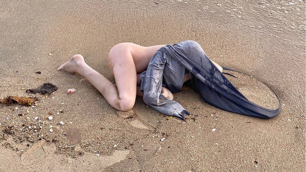 Story from Jam Press (Beach Body)  Pictured: The sex doll that washed up on the beach.  ‘Dead body’ on tourist hotspot beach turns out to be SEX DOLL.  Beach-goers who were horrified after spotting what they believed to be a naked corpse have left police laughing – as the 'body' turns out to be something much less sinister.  The incident took place on Bang Saen beach in the Thai province of Chon Buri last week (18 August).  Photos shows the bizarre situation, with what appears to be a naked leg clearly visible in the image.  However, as it turns out, there was no crime at hand; the body was in fact a hyper-realistic sex doll, allegedly a Japanese model branded as 'AV Idol'.  Before the crime was ‘solved’, panicked beach-goers called the police.  Paramedics and police officers rushed to the scene and came across the ‘victim’, which turned out to be the realistic sex doll with its bum on show.  According to an internet search, the doll is estimated to cost THB 20,000 (£469).  Police believe the product was dumped in a canal or river, before making its way to the sea.  Despite missing its head, the item is being kept at the local police station in case the owner wants to pop in to reclaim it.  ENDS