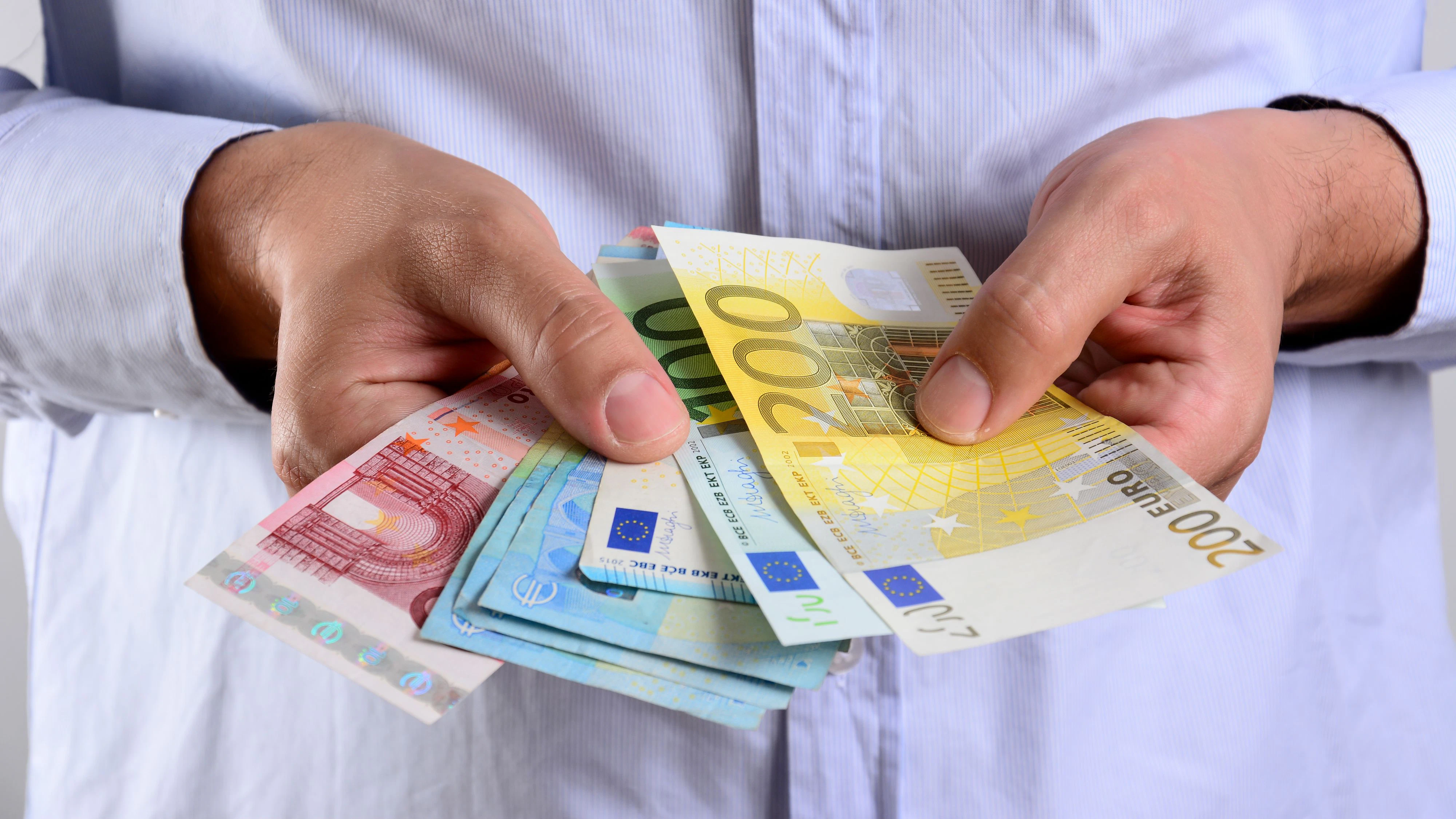 The love of money. Hands holding Euro banknotes.