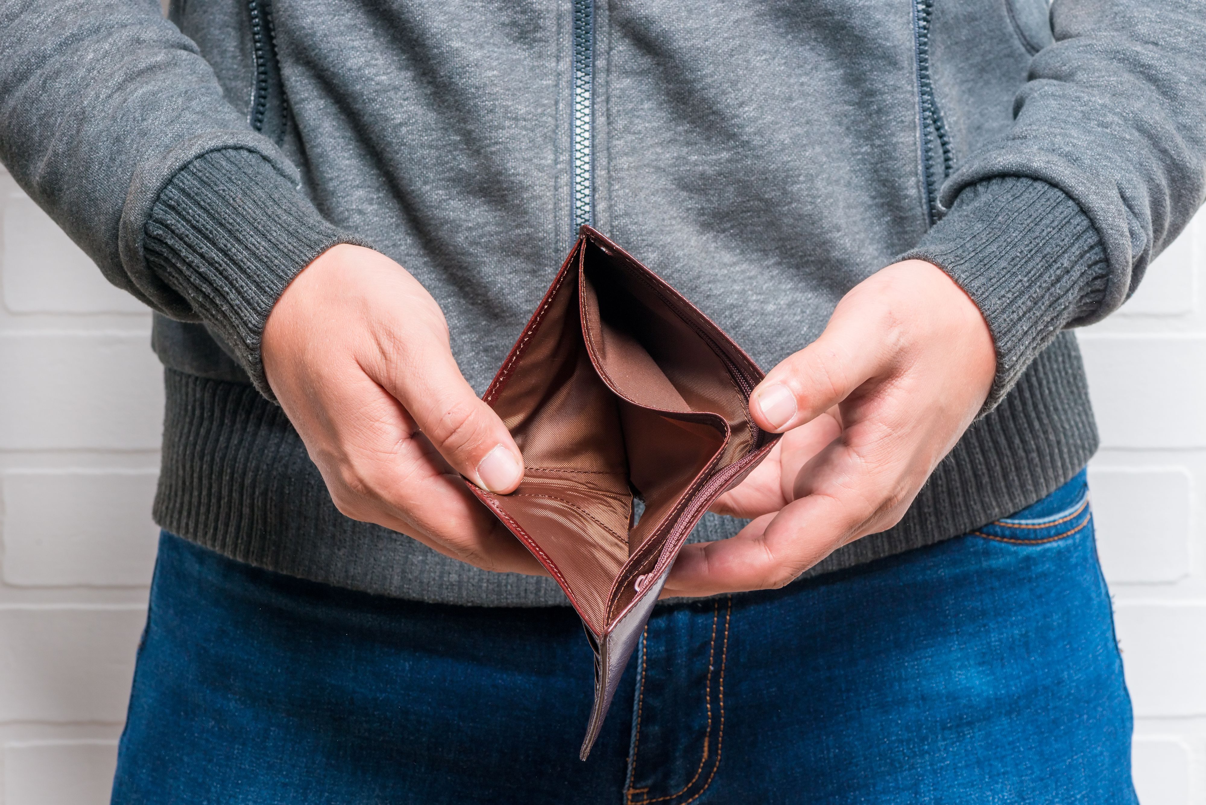 Close-up of empty purse in man's hands