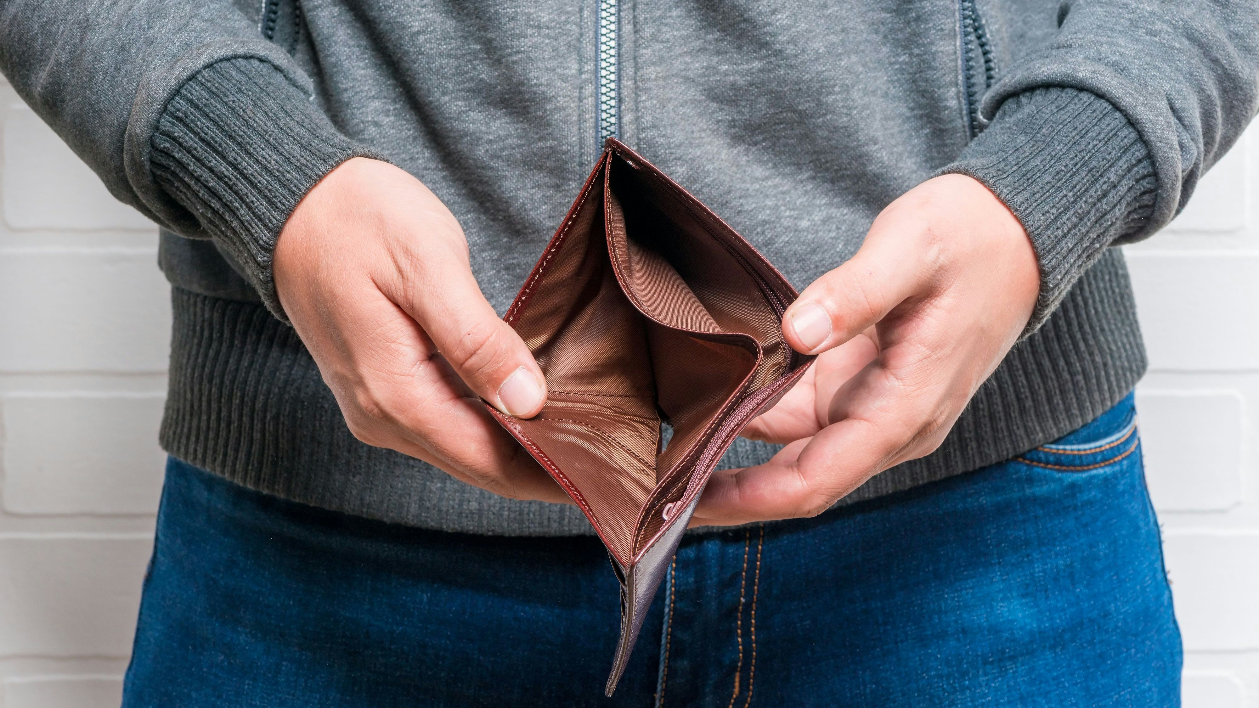 Close-up of empty purse in man's hands