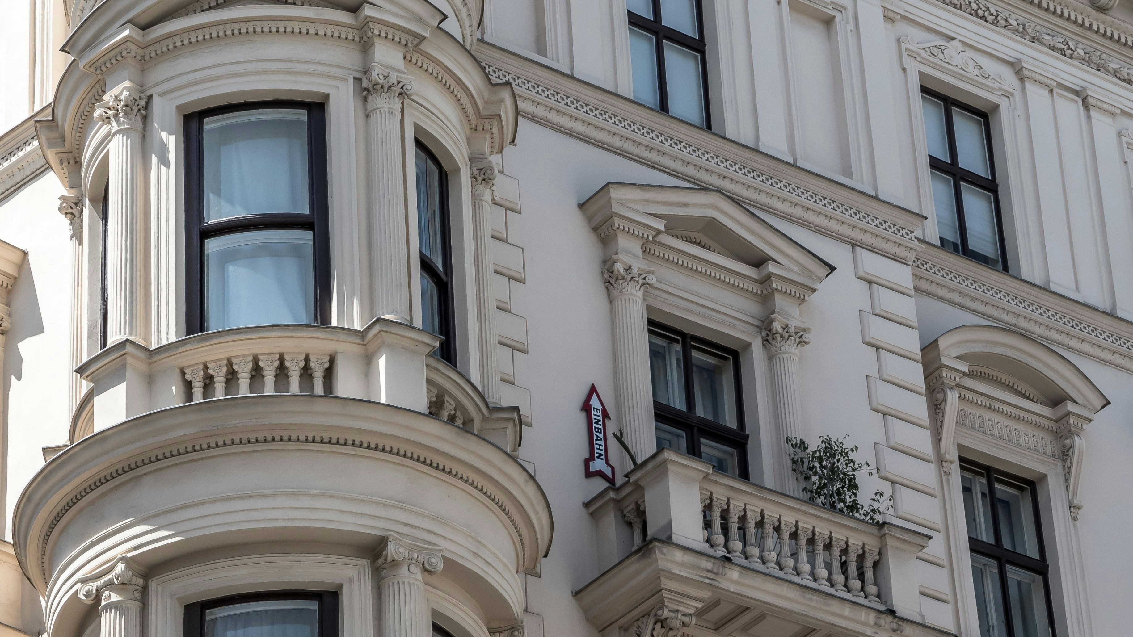 Facade Of An Old Building With Balcony And Funny One Way Sign In The City Of Vienna In Austria