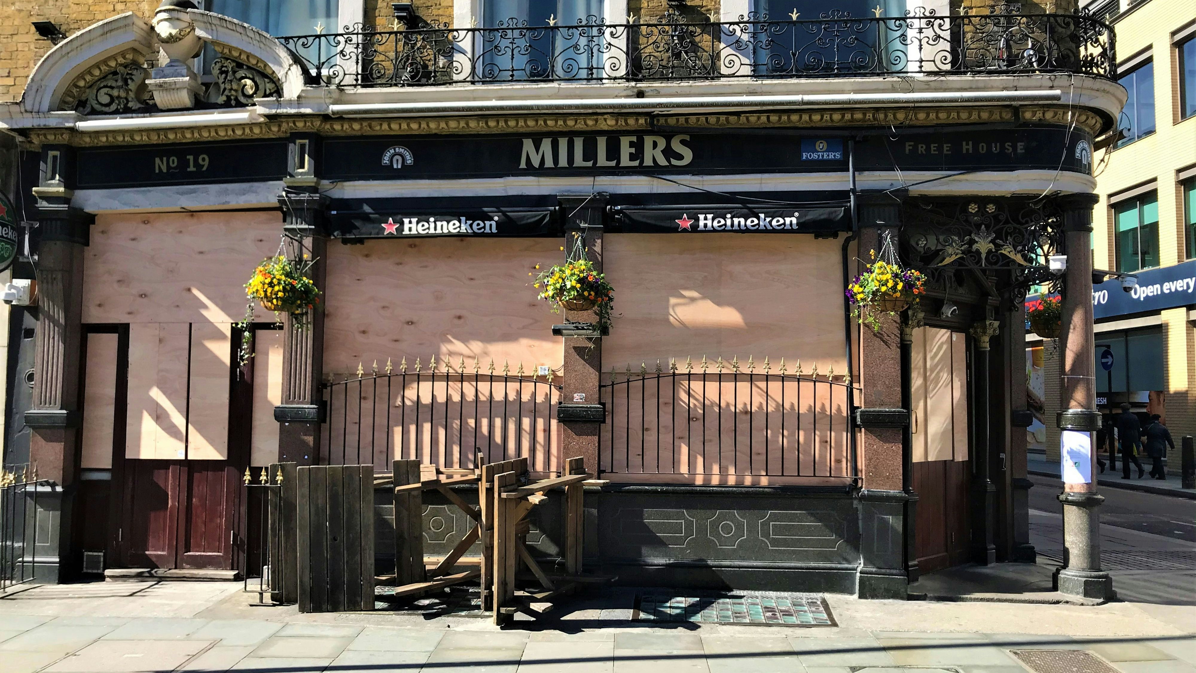London, United Kingdom - March 22 2020: London pub closed and boarded up during shutdown no people empty street