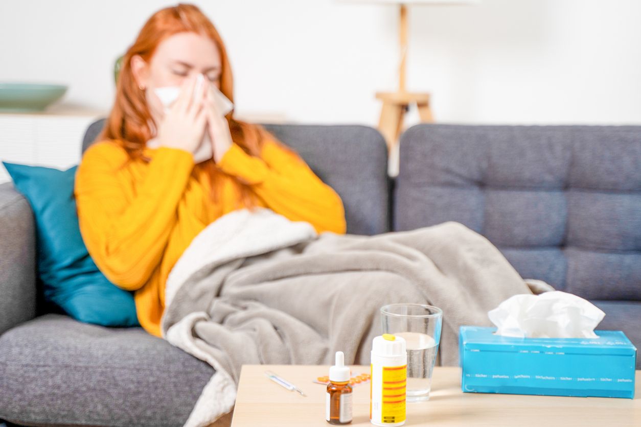 Sick woman with fever symptoms at home