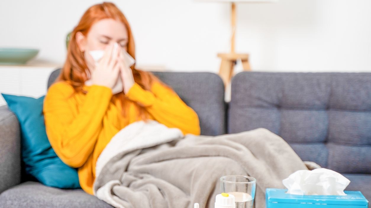 Sick woman with fever symptoms at home