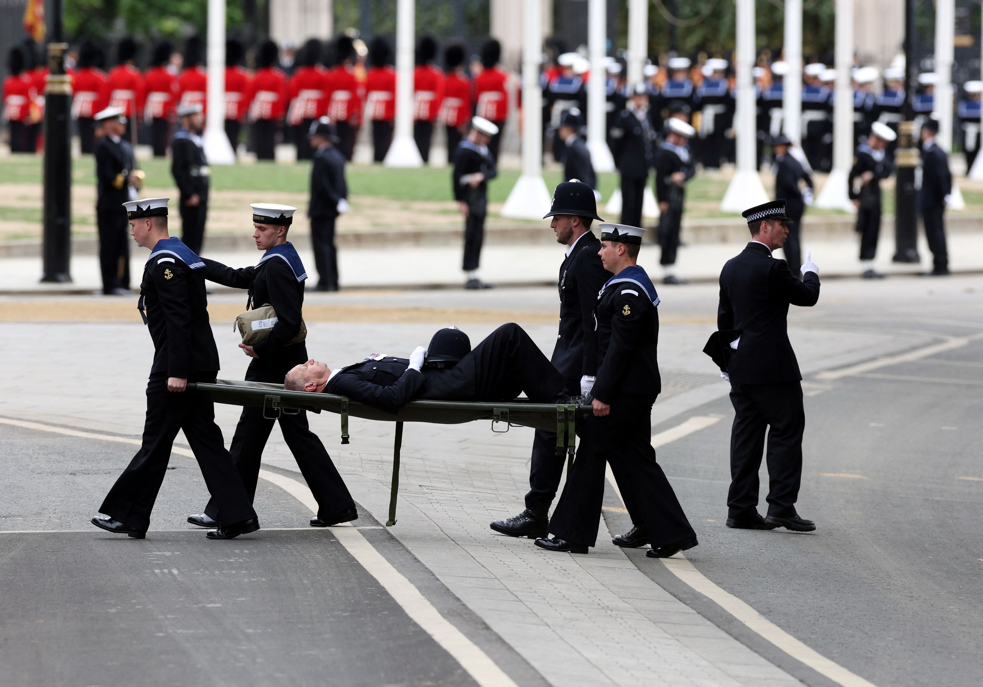 A Policeman collapses at the funeral of the Queen, Westminster Abbey, London. September 19, 2022. Marc Aspland/Pool via REUTERS