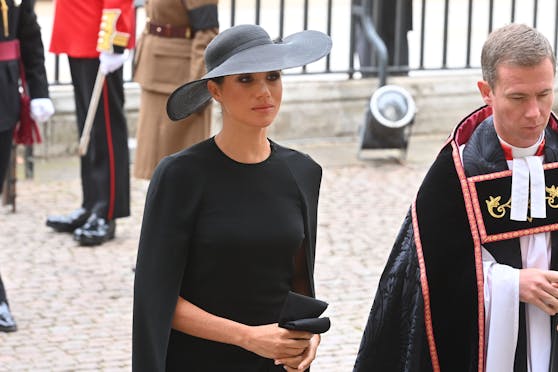 Herzogin Meghan erschien in einem schwarzen Stella-McCartney-Kleid mit integriertem Umhang.