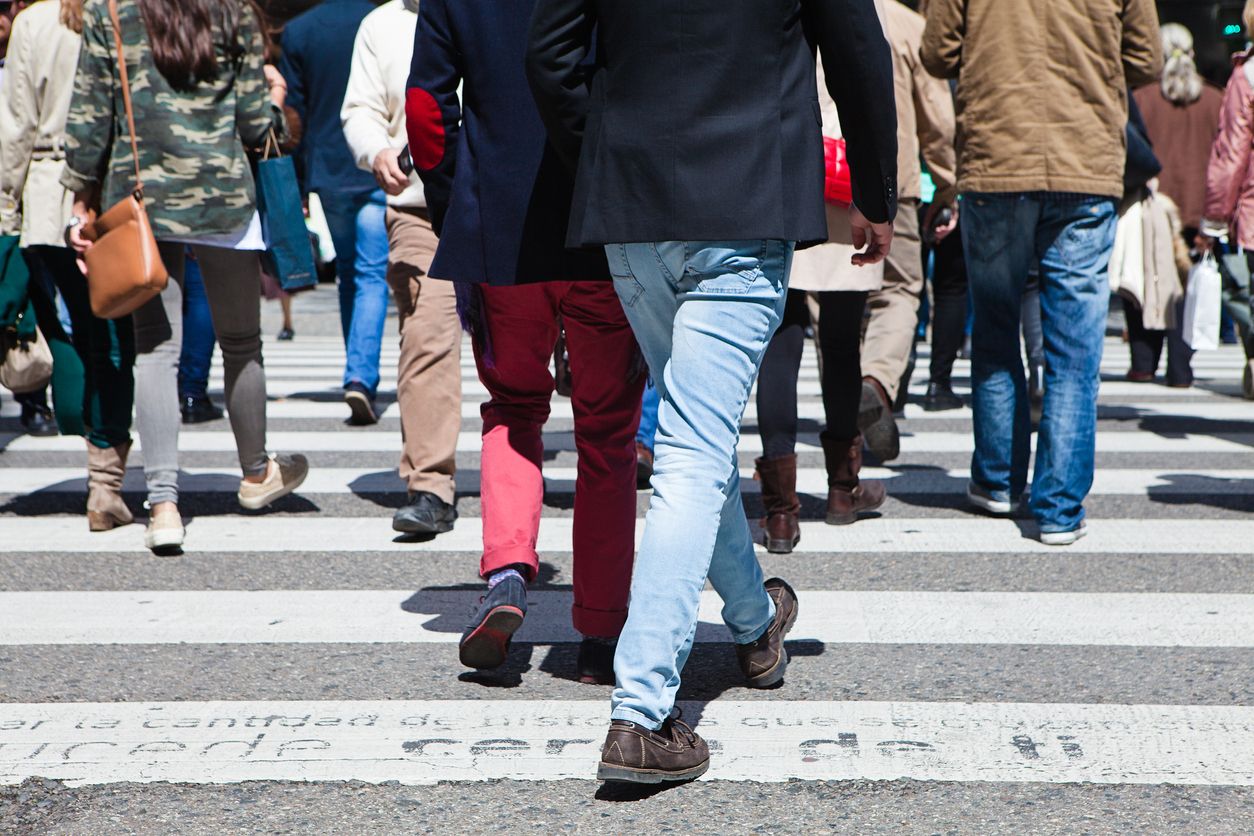 Group of people crossing crosswalk in the city