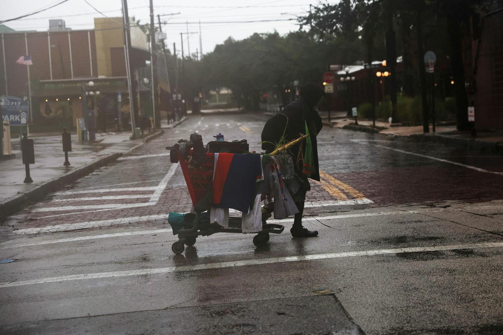 Ein Mann trägt seine Sachen über die Straße, als Hurrikan Ian im Südwesten Floridas, im Stadtteil Ybor City von Tampa, Florida, USA, am 28. September 2022 auf Land trifft.