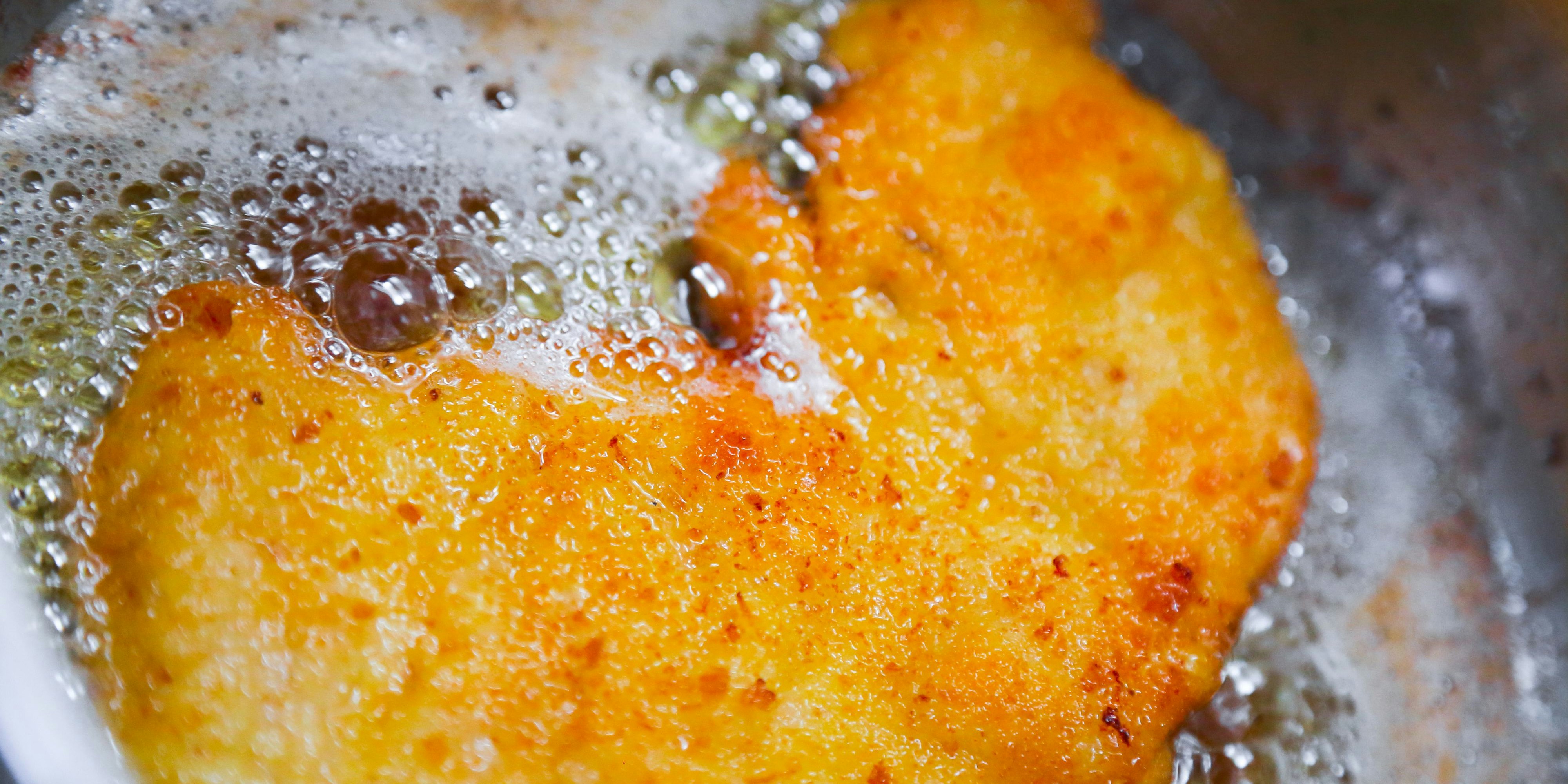 Deep fried meat coated in bread crumbs in hot oil.