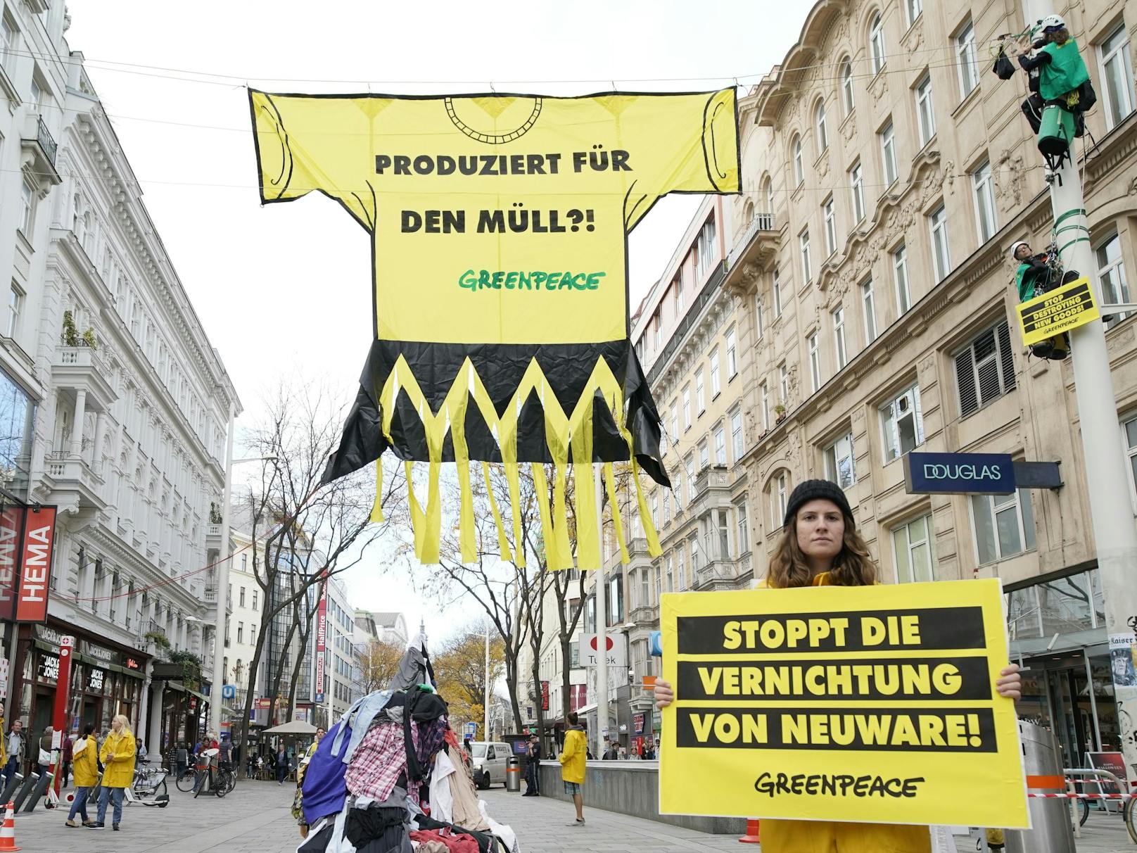 Greenpeace-Aktivisten spannen riesiges, zerschreddertes T-Shirt über die Wiener Mariahilfer Straße als "Mahnmal gegen die Wegwerf-Kultur".