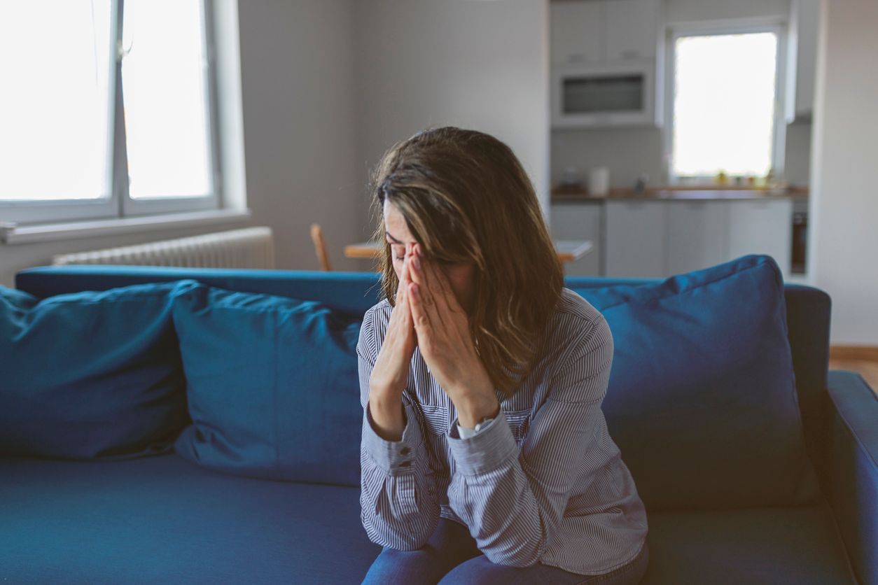 Senior Woman at Home Suffering From Headache, Emotions and Stress With Migraine and Dizziness. Mature Woman Suffering From Stress or a Headache Grimacing in Pain