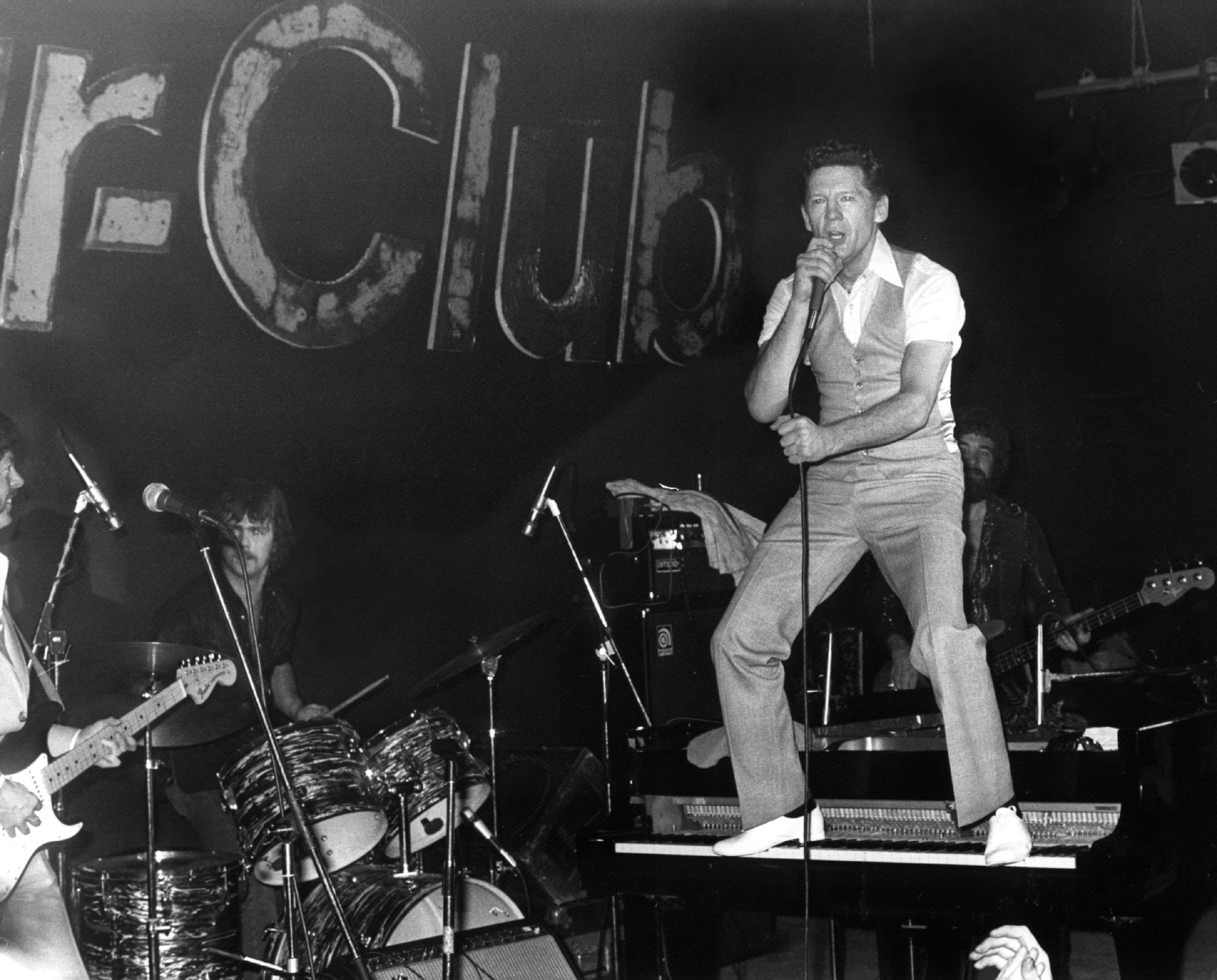 Der amerikanische Rock-Musiker Jerry Lee Lewis 1980 im Hamburger Star-Club die Fans. Nach großen Erfolgen in den 50-er Jahren (u.a. "Great Balls Of Fire", "High School Confidential") wurde es um den skandalträchtigen RockÂn Roller ruhiger. Durch seine dritte Ehe mit der erst 13-jährigen Myra Gale Brown wurde er, nach einer Kampagne der Kirche, zur Unperson. Kleinere Erfolge konnte er zwar, besonders in den Country-Charts, weiterhin verbuchen, der große Durchbruch gelang jedoch nicht mehr. Sein Privatleben war von Schicksalschlägen geprägt: Ein Sohn ertrank, ein anderer verunglückte tödlich, eine spätere Ehefrau ertrank ebenfalls, die Nachfolgende starb an einer Überdosis Heroin. Trotz finanzieller sowie durch Alkohol- und Rauschgiftmissbrauch bedingter gesundheitlicher Probleme gab Lewis nie auf. Im Sommer 1997 wurde seine Europa-Tournee in ausverkauften Hallen bejubelt. Jerry Lee Lewis wurde am 29. September 1935 in Ferriday (Louisiana) geboren. 
