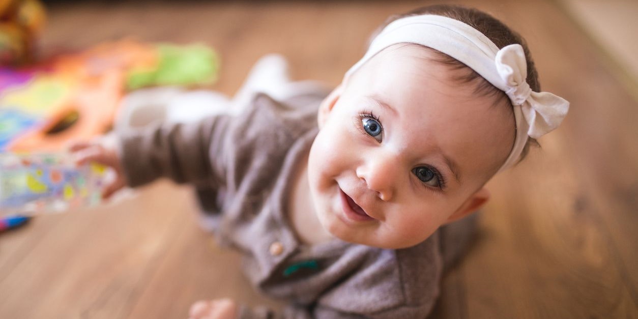 Adorable Baby Girl Learning How To Crawl At Her Warm Home