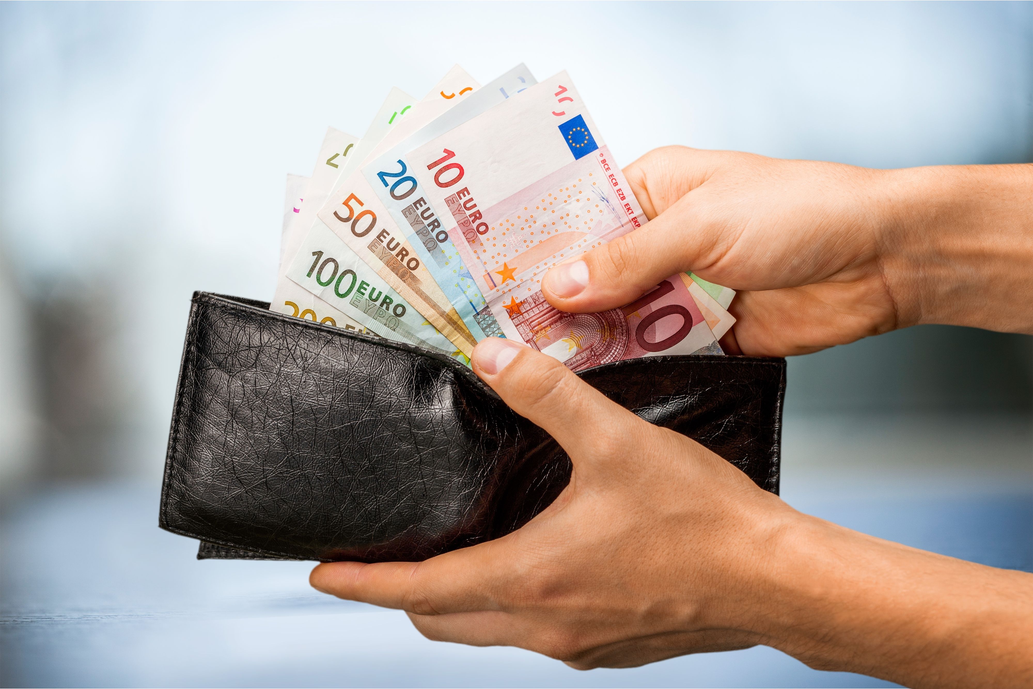 Pulling money out of wallet, close-up view