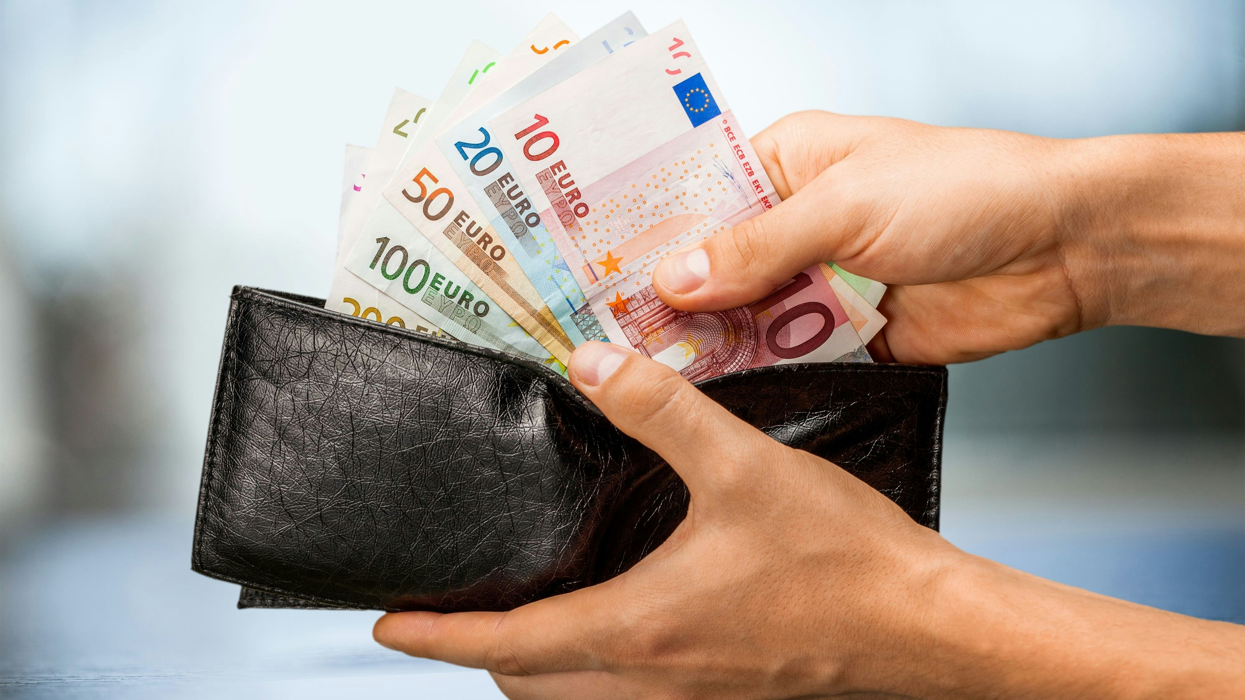 Pulling money out of wallet, close-up view